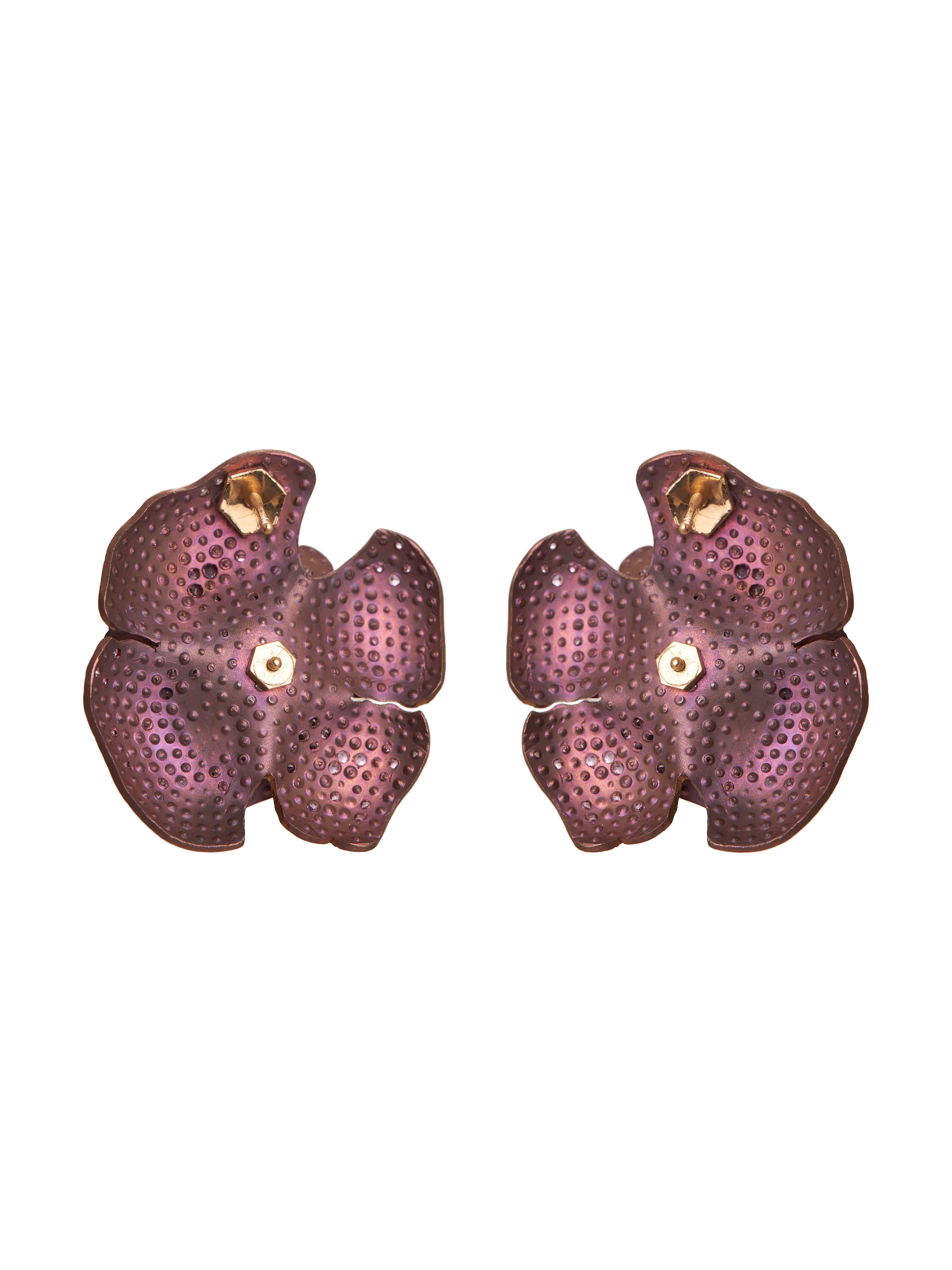 The Pink Double Flower Earrings from the Titanium collection are a stunning embodiment of elegance and grace, crafted precisely from luxurious 18KT gold and titanium. Designed to resemble two delicate, blooming flowers, these earrings capture the
