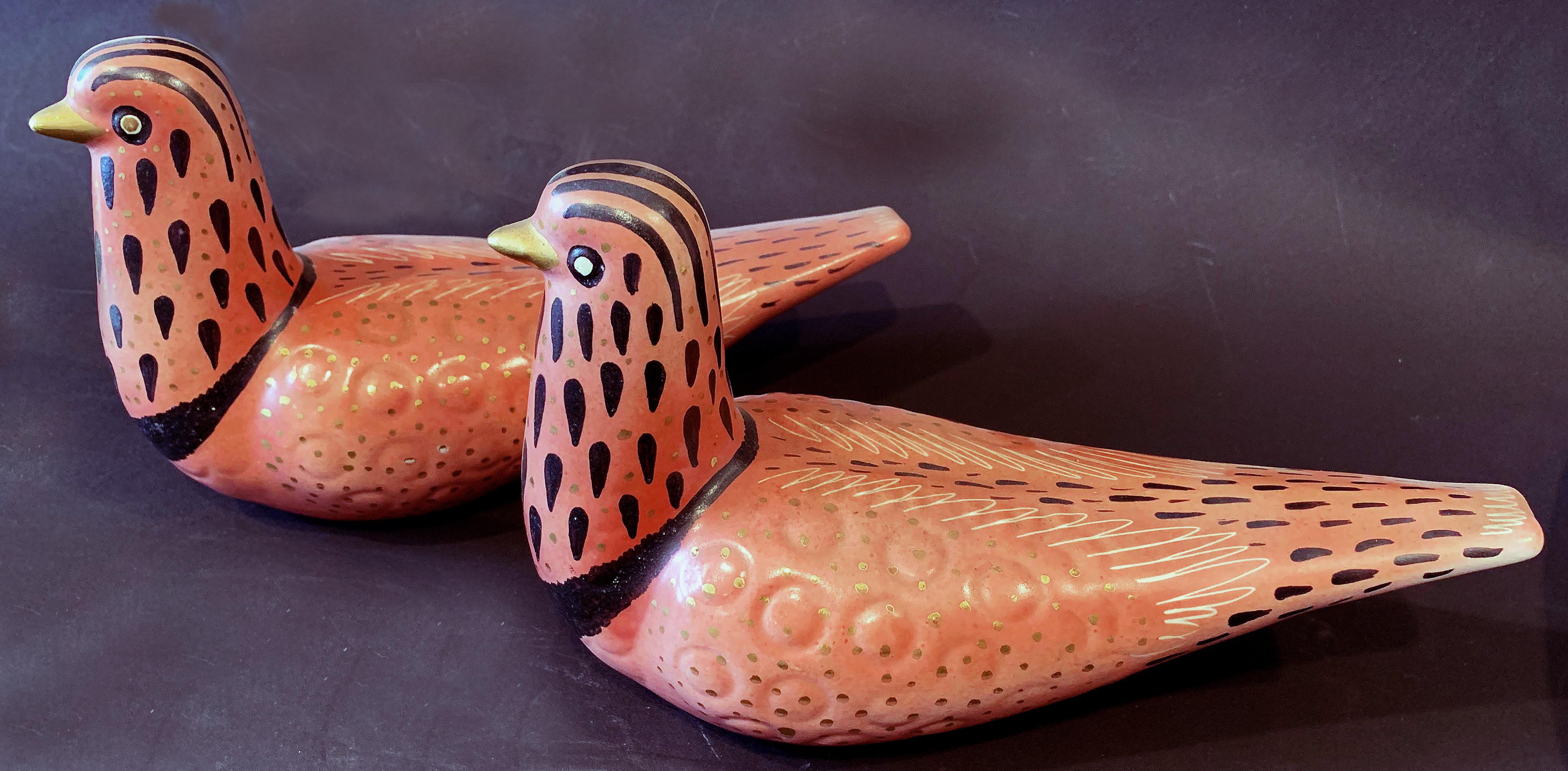 Glazed in a deep pink color overlaid by an elaborate pattern of markings in black and gold, this pair of ceramic doves was sculpted and glazed by Waylande Gregory, one of America's 20th century greatest sculptors in clay and metal. Gregory was a