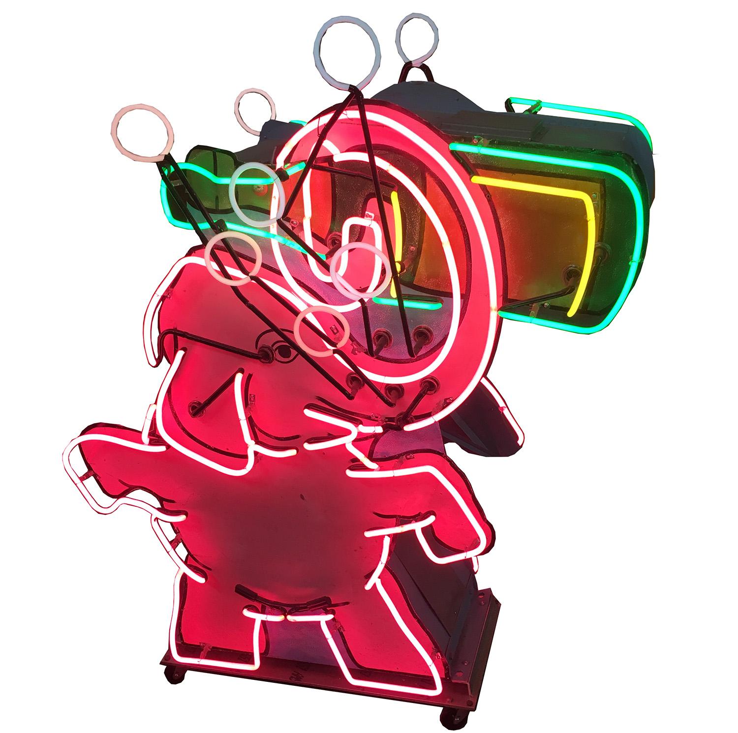 This whimsical pink elephant neon sign came from a 1950s liquor store in the Palm Springs area. He holds an animated bubbling bottle of champagne. The sign is double sided, with neon and the painted images on both sides. It is free standing, and we