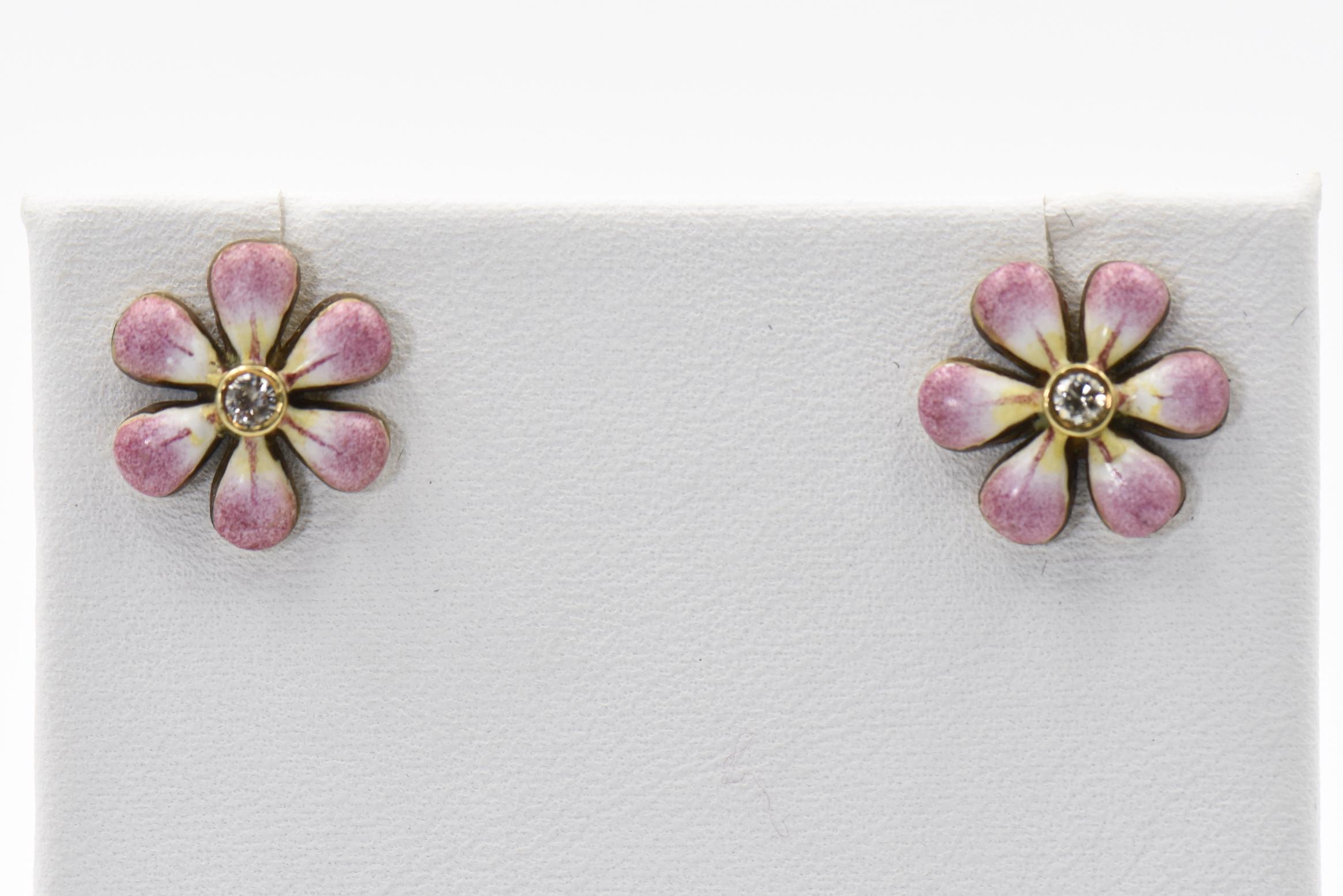 This pair of pink enamel daisy earrings are part of the daisy line, a beautiful handmade line of jewelry by Sandra J. Sensations. Each flower is hand painted by an enamel artist. The flowers are 14k with diamonds in the center. Each diamond is