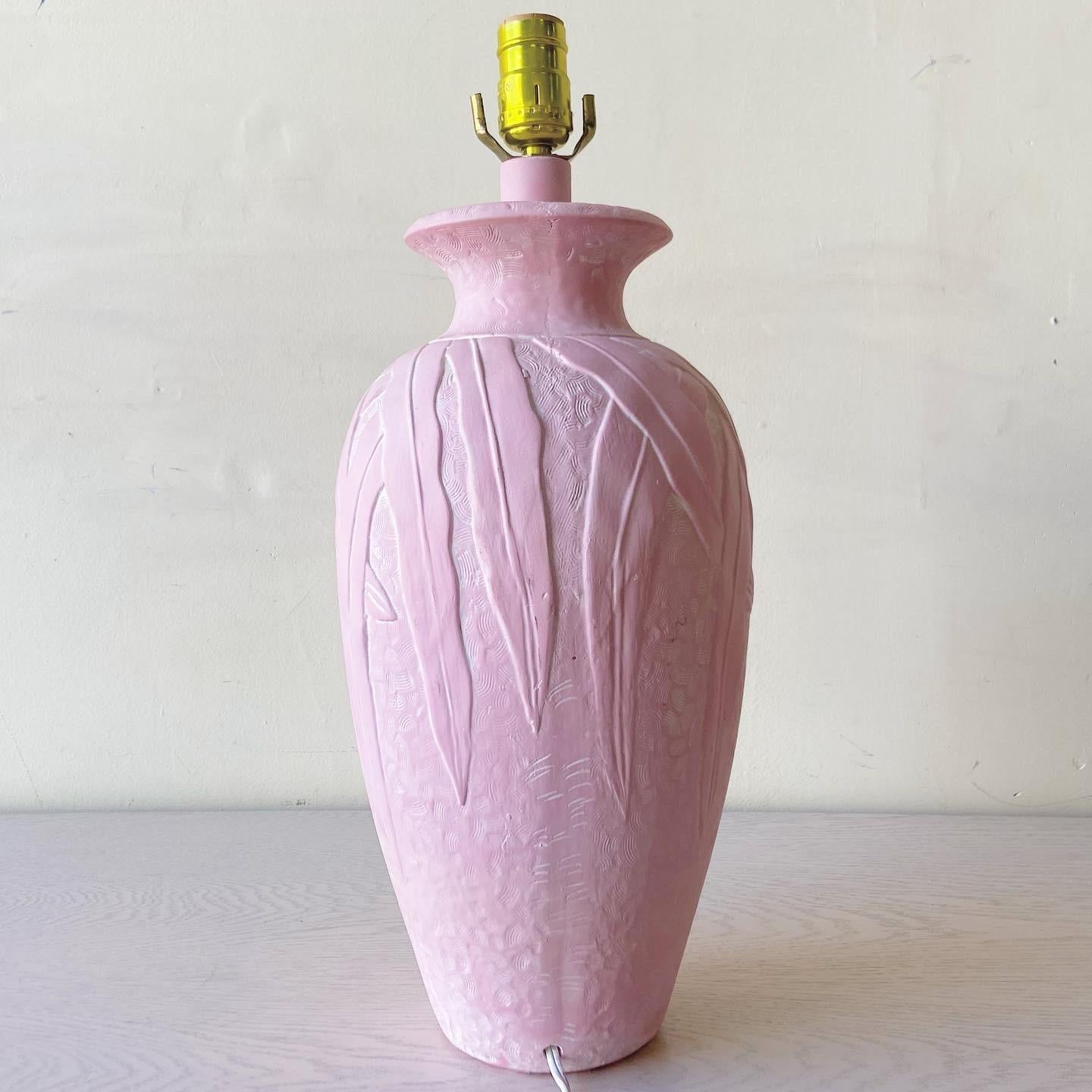 Incredible pink ceramic table lamp. Features little grooves tessellating the lamp beneath banana leaves.

Additional information:
Material: Ceramic, Plaster
Color: Pink
Style: Postmodern
Time Period: 1980s
Place of origin: USA
Dimension: 8ʺ W × 8ʺ D