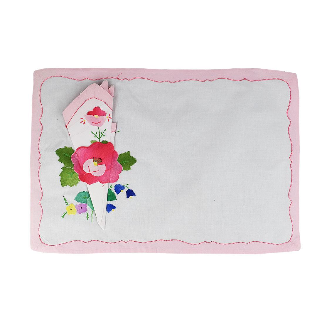 Set of four floral pale pink cloth placemats and matching napkins. A wonderful accent to a table setting, each set includes one placemat with a matching napkin. A pastel pink scalloped edge lines the outside of each placemat. At the bottom left,