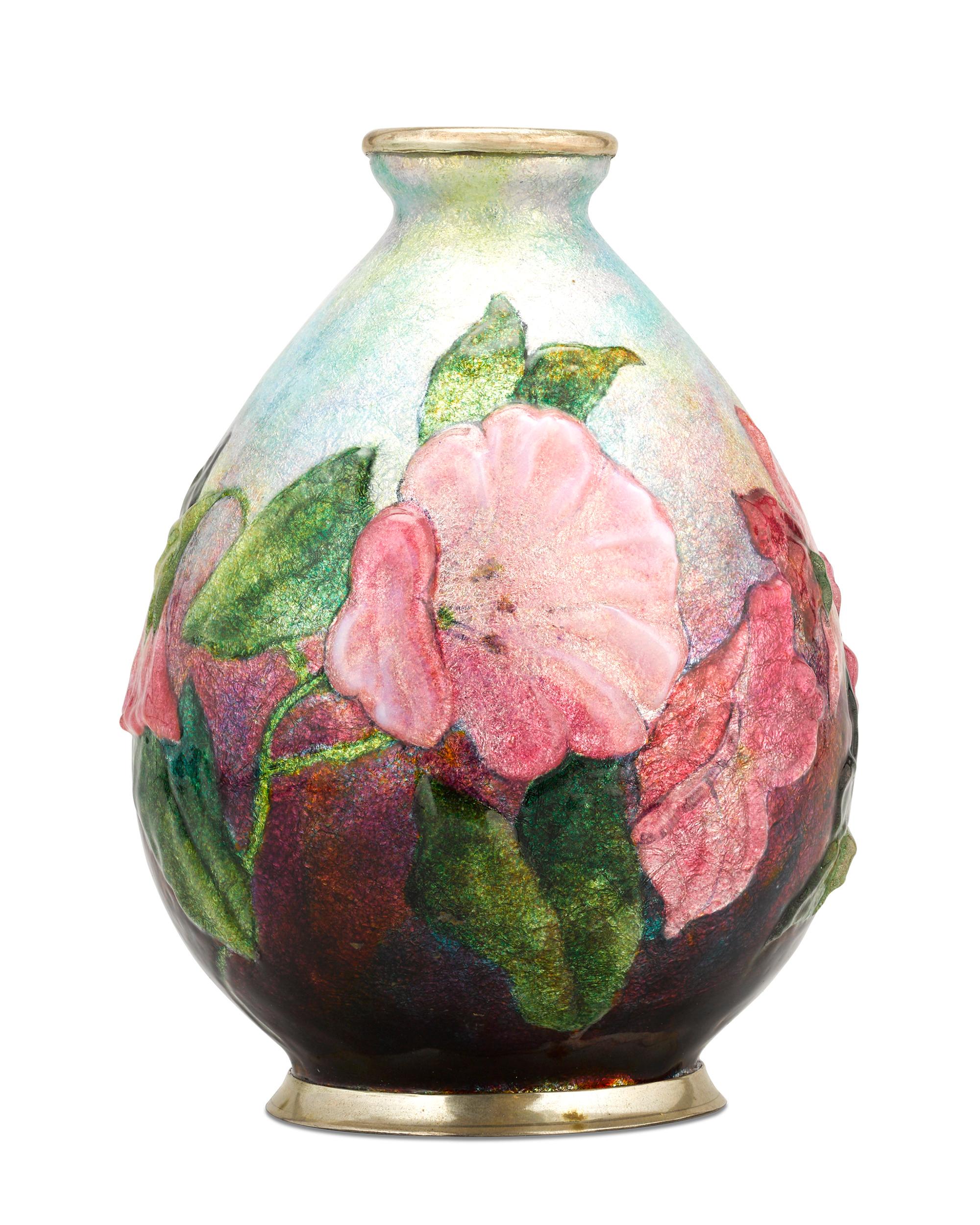 This charming floral vase by master Art Deco decorative artist Camille Fauré possesses both a visual and tactile beauty achieved through Fauré's signature enameling technique. Starting with a copper vase form covered in silver leaf, layers of