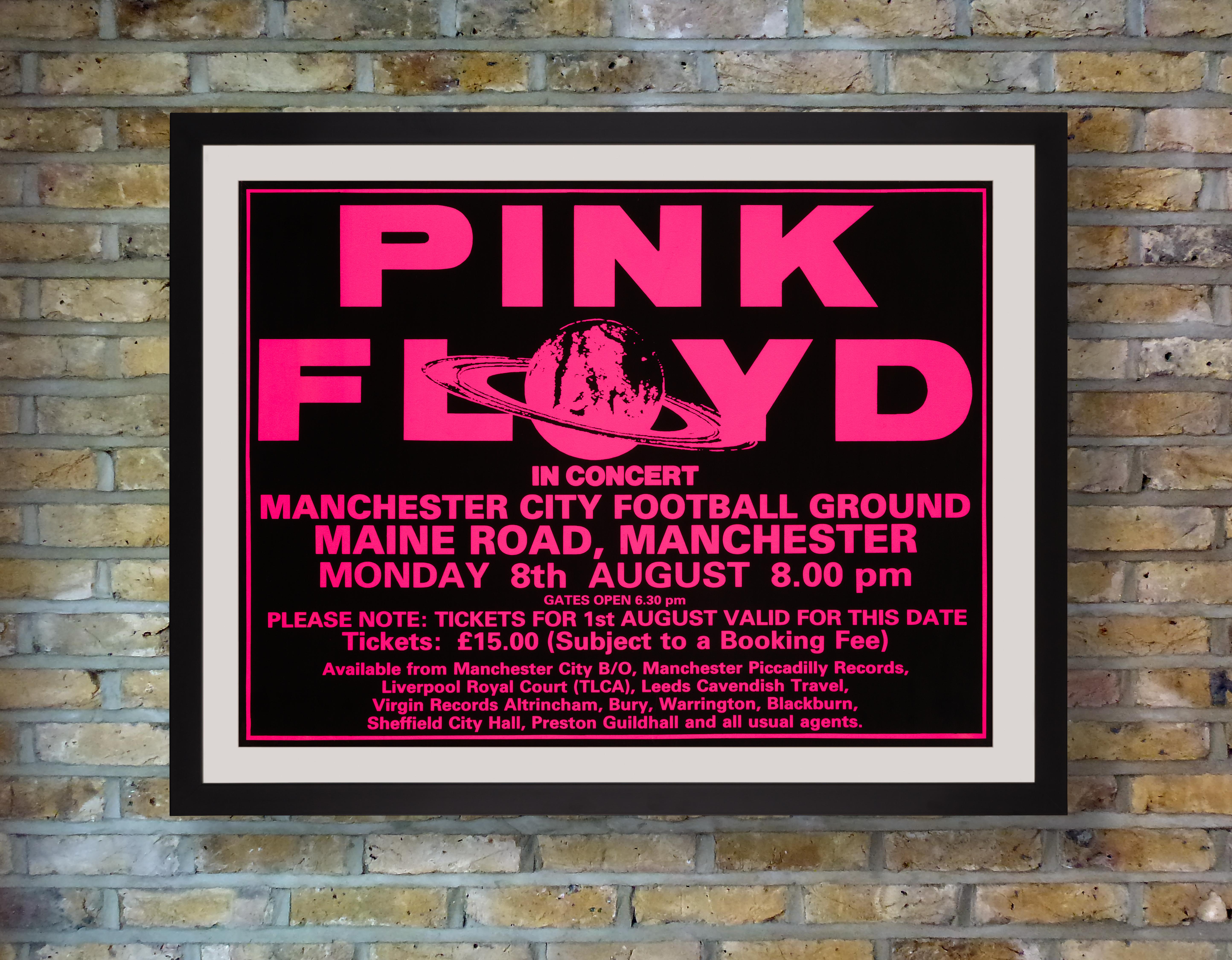 A shocking fluoro pink and black silkscreen poster for a performance by Pink Floyd at Manchester City Football Ground, Maine Road, Manchester, England, on 8th August 1988 during the first European leg of the band's mammoth A Momentary Lapse of