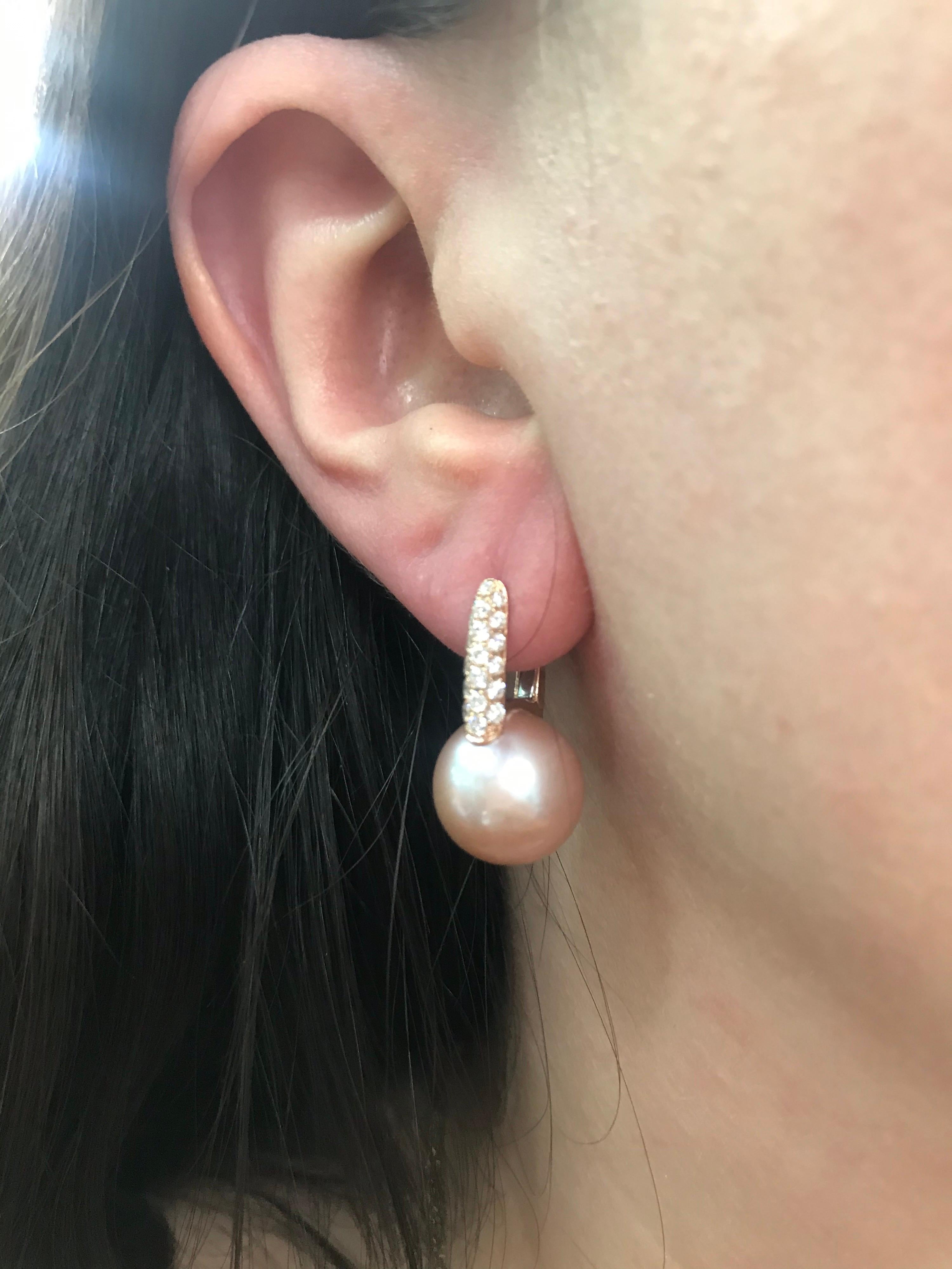 18K Rose gold drop earrings featuring two pink Freshwater pearls measuring 12-13 mm and 38 round brilliants 0.61 carats. 

