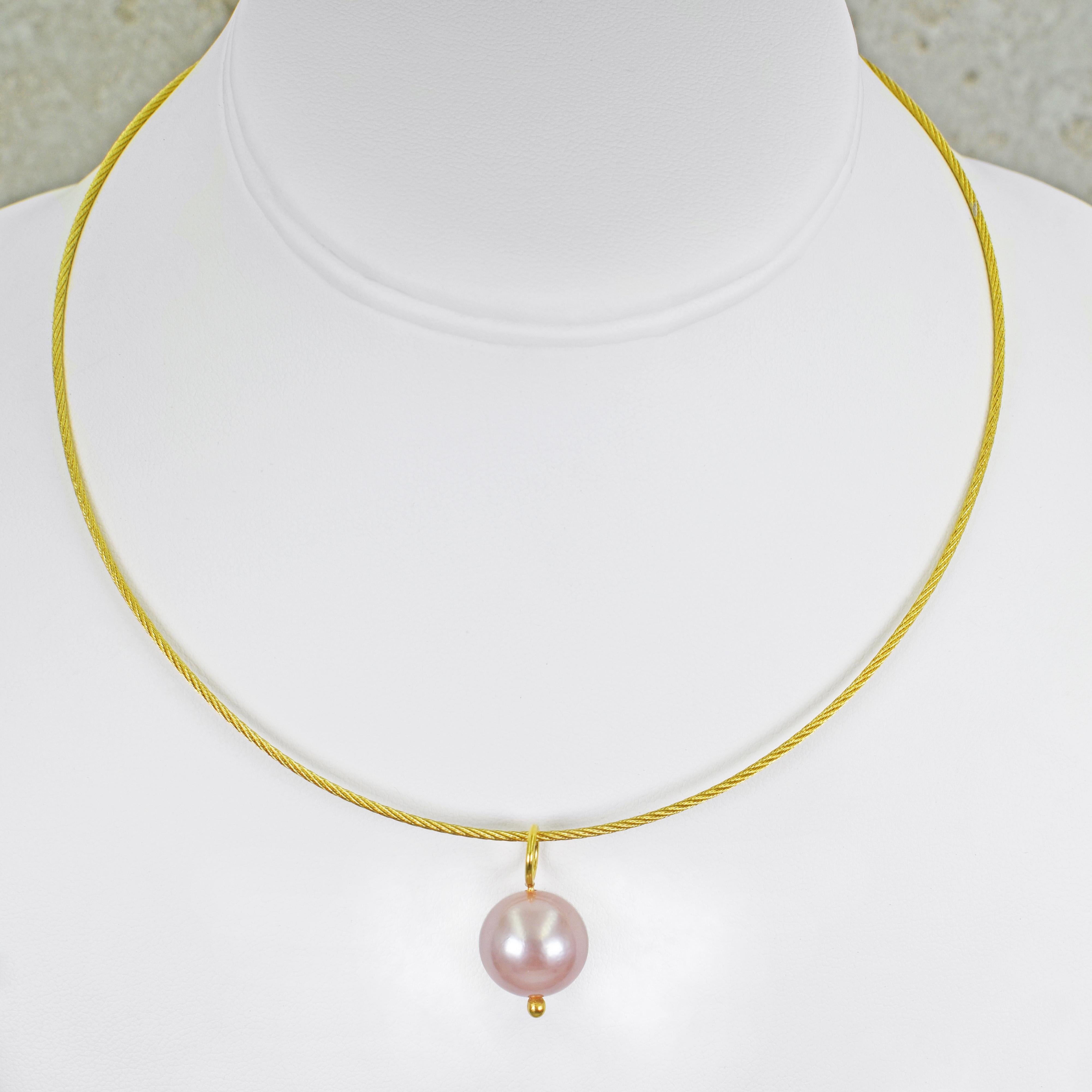 Pink freshwater pearl and 18k yellow gold pendant necklace and drop earring set. Necklace is composed of a round 14.5mm pink pearl pendant on a 16 inch 18k gold woven cable wire necklace and finished with a safety clasp (crocodile clasp). Earrings