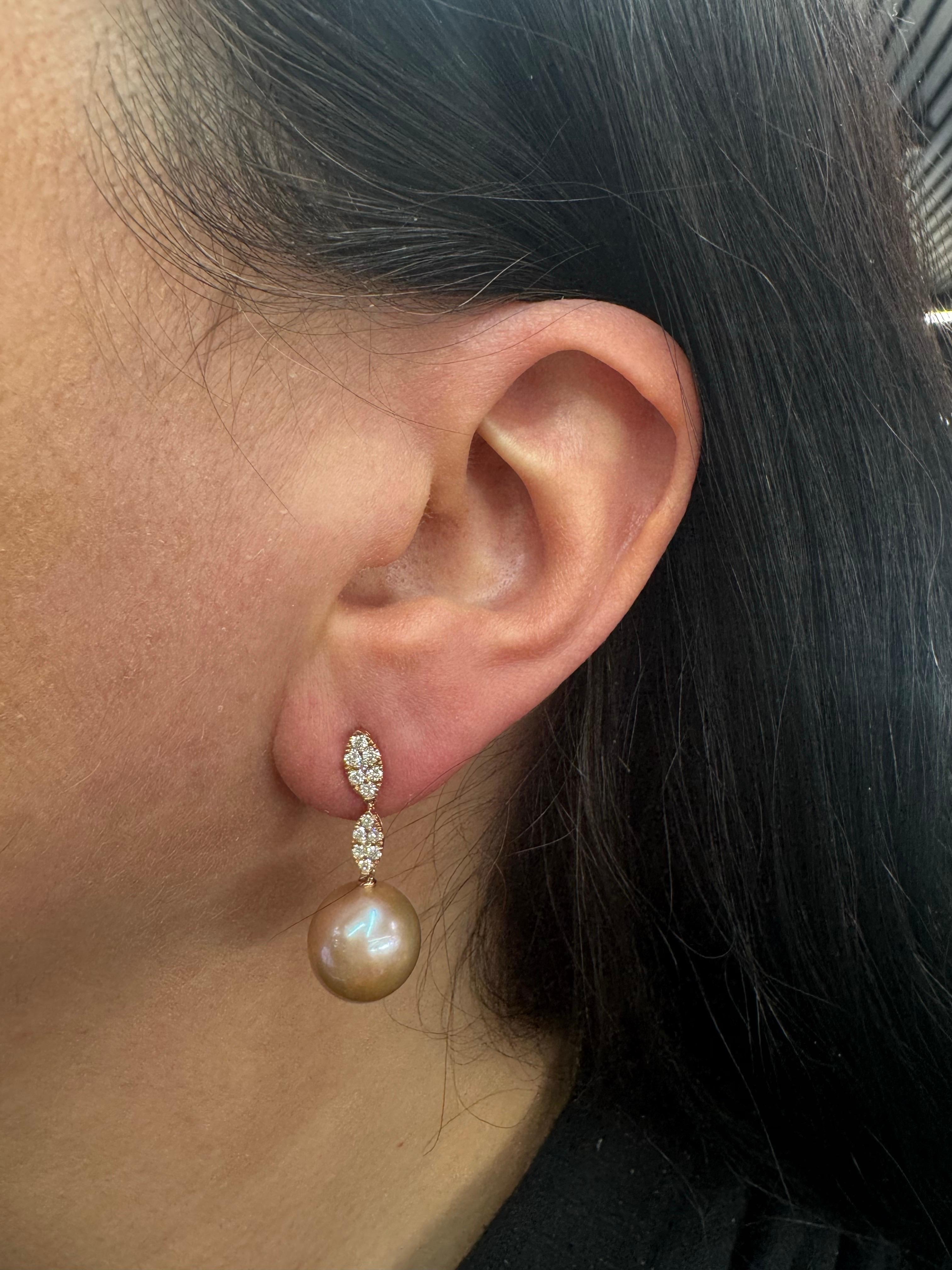 18 Karat rose gold drop earrings featuring 28 round brilliants weighing 0.45 carats and two Pink Freshwater pearls measuring 11-12 MM. 