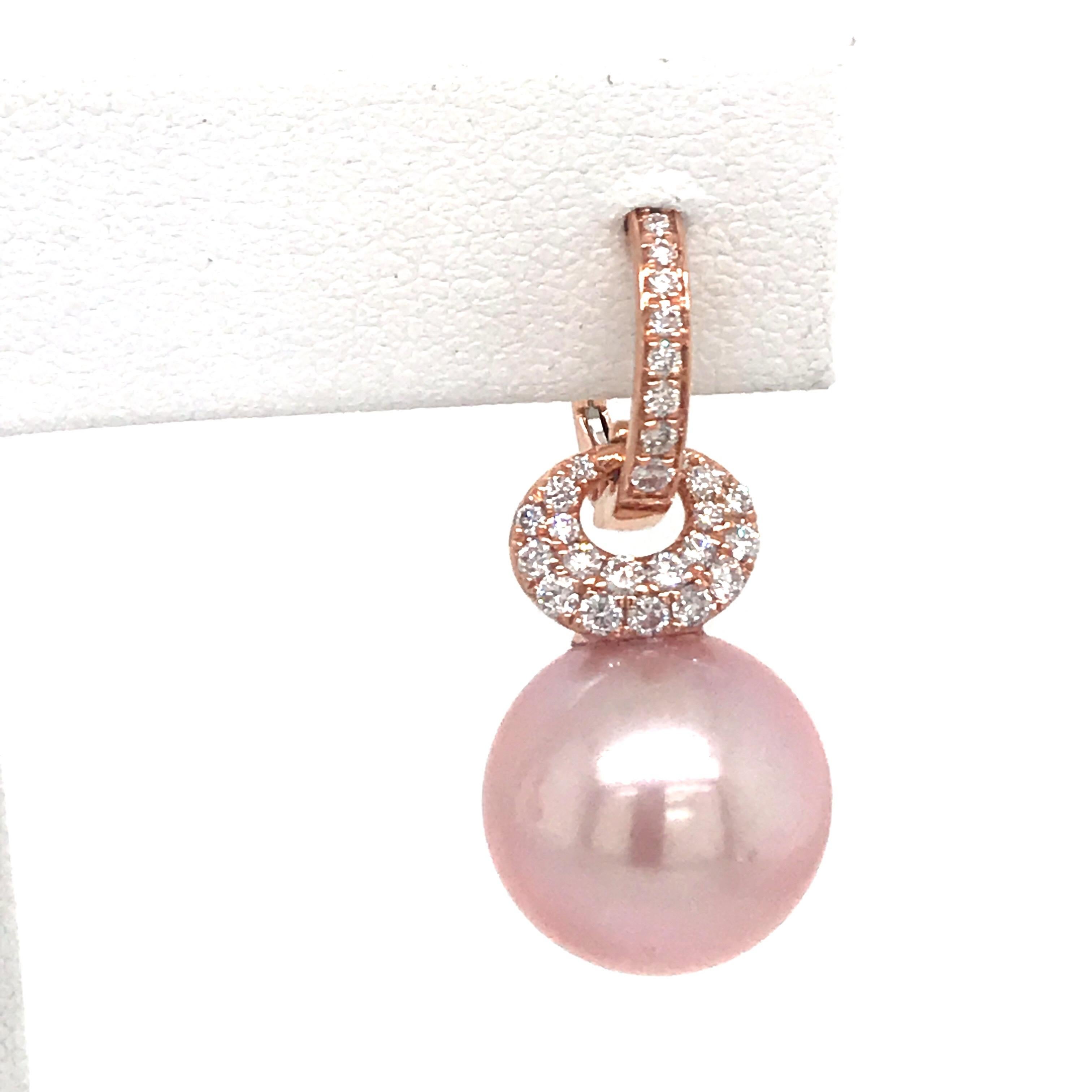 18K Rose gold drop earrings featuring two pink Freshwater Pearls measuring 12-13 mm and 56 round brilliants weighing 0.57 carats. 
Color G-H
Clarity SI