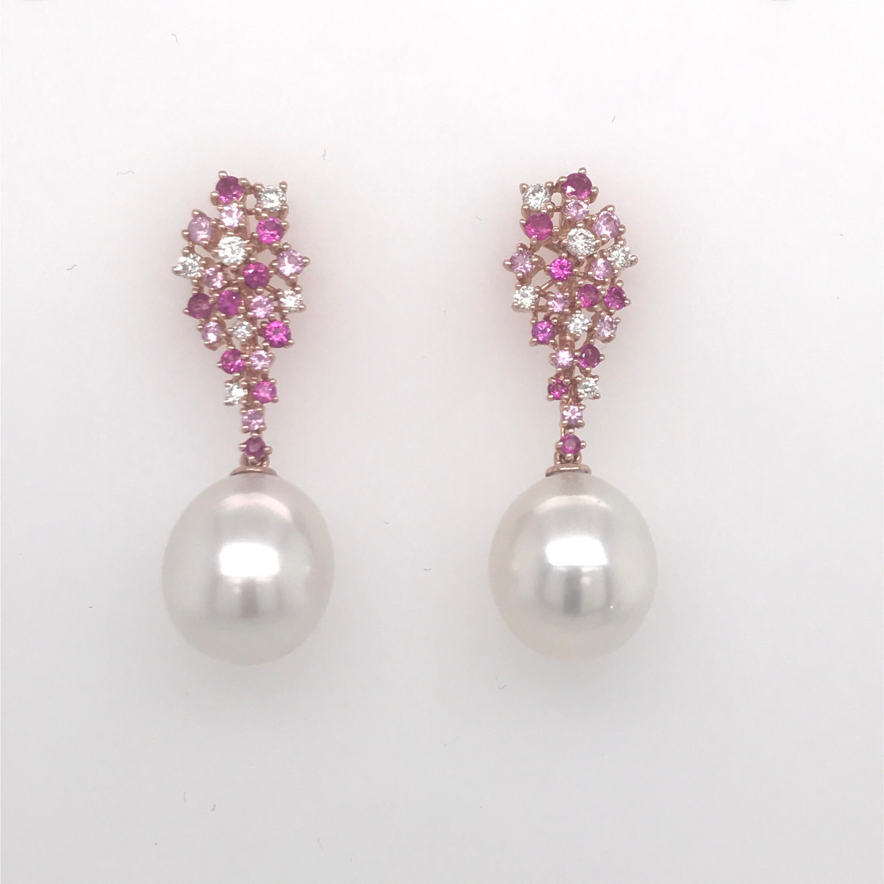 18K Rose Gold earrings featuring two pink Freshwater pearls measuring 12-13 mm flanked with 34 pink sapphires, 1.07 carats, and 12 round brilliants, 0.34 carats. 