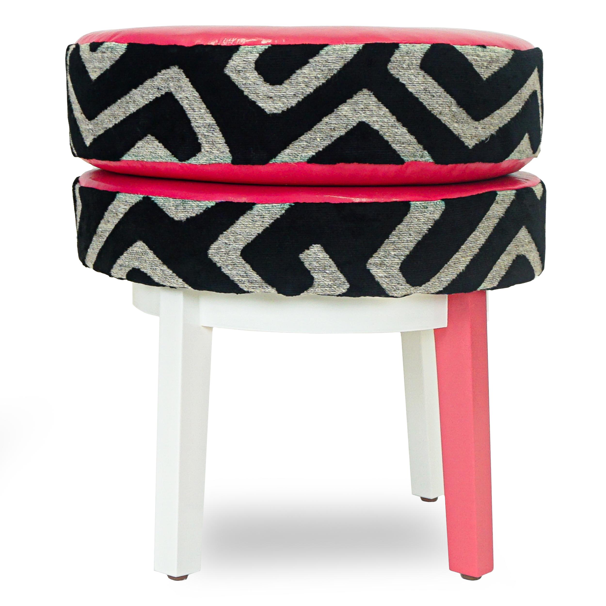 Small round stool upholstered in a velvet wool geometric by Jim Thompson and trimmed with a hot pink vinyl and black velvet inside. Frame is solid poplar wood lacquered in white with one hot pink accent leg. Sturdy base with a comfortable firm foam