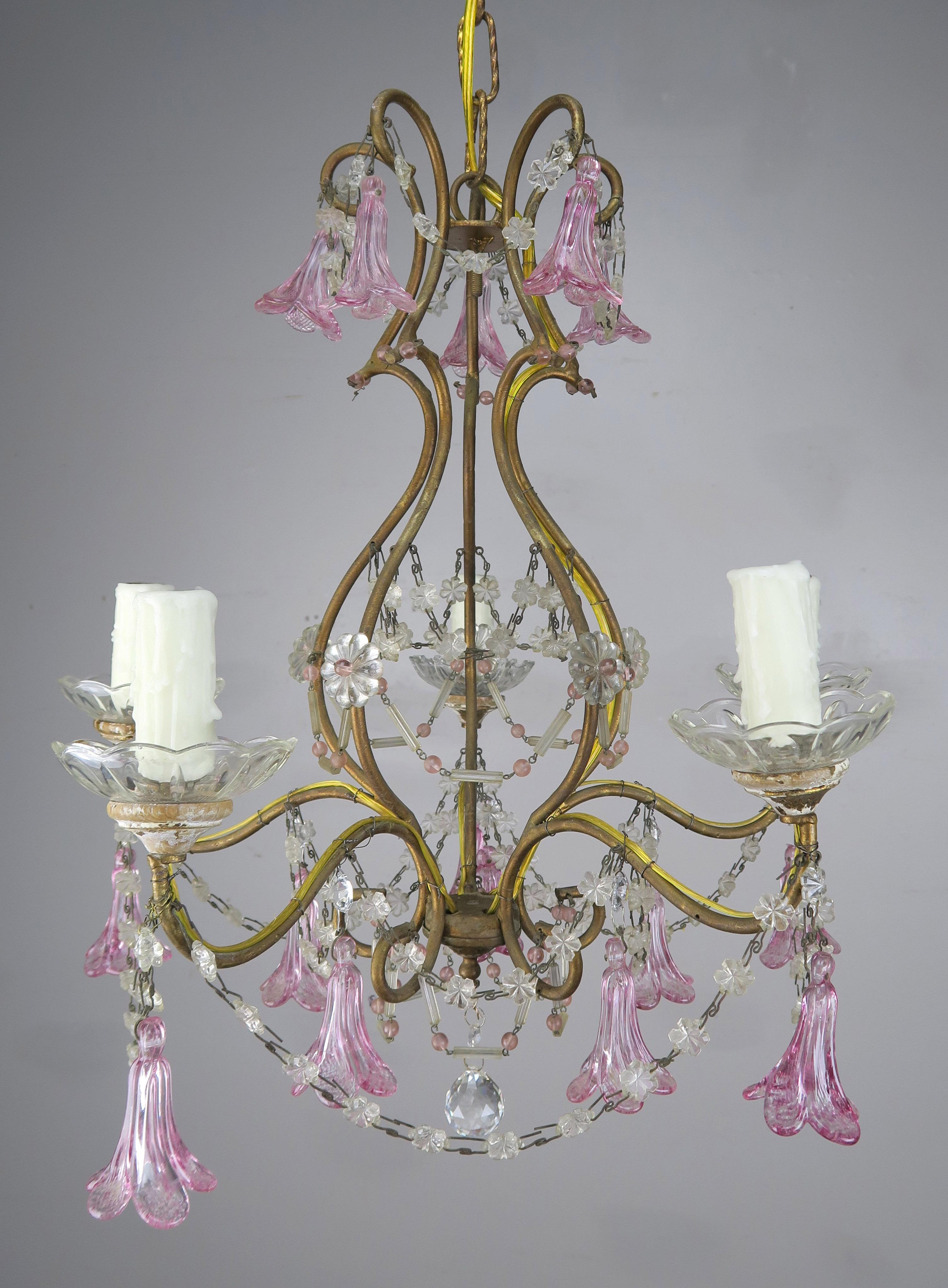 Four light Italian crystal brass chandelier with hand blown pink flower glass drops throughout combined with garlands consisting of pink and clear beads. The fixture is newly rewired with drip wax candle covers. Includes chain and canopy.