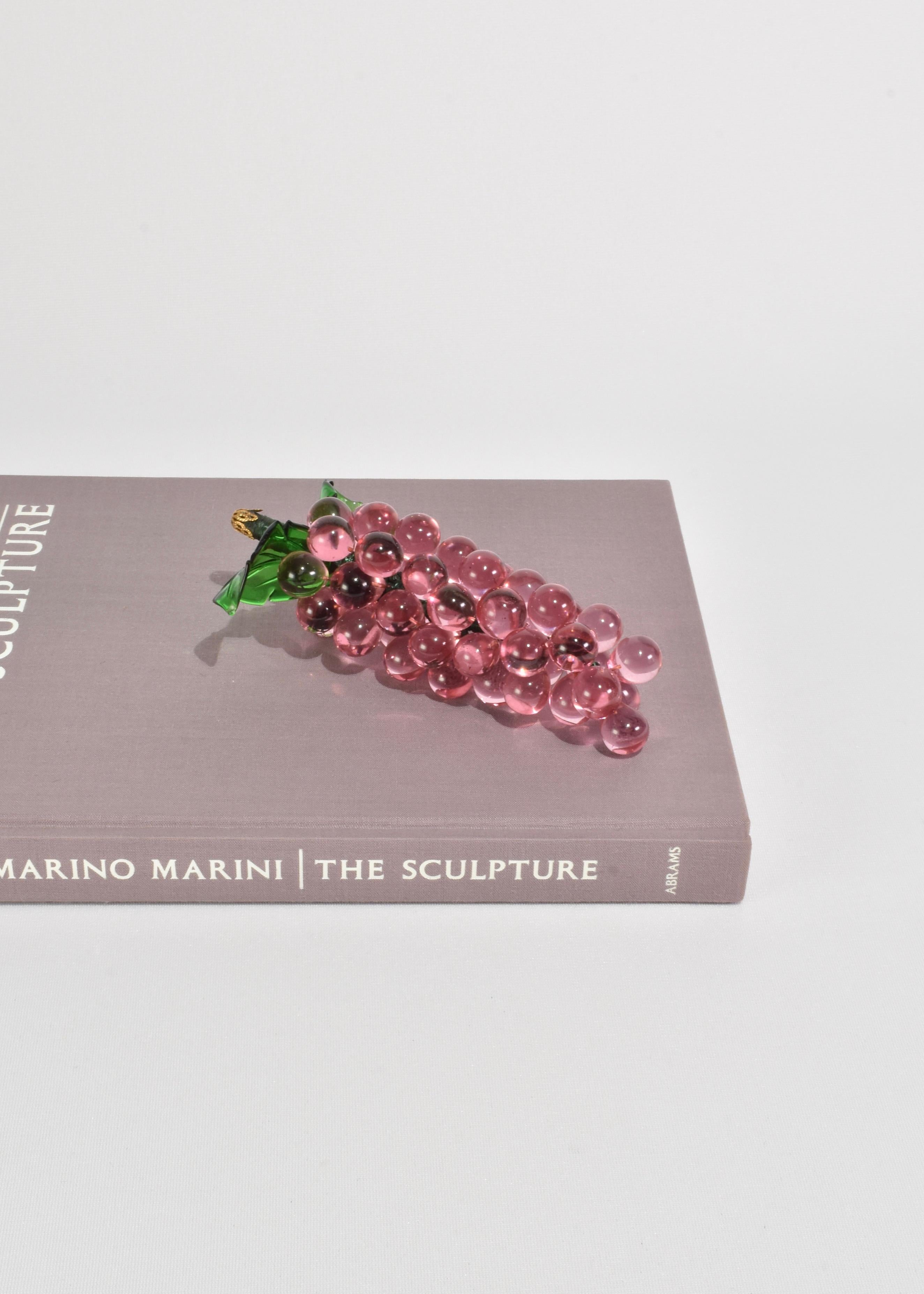 Vintage, pink glass grape sculpture with acrylic green leaves.