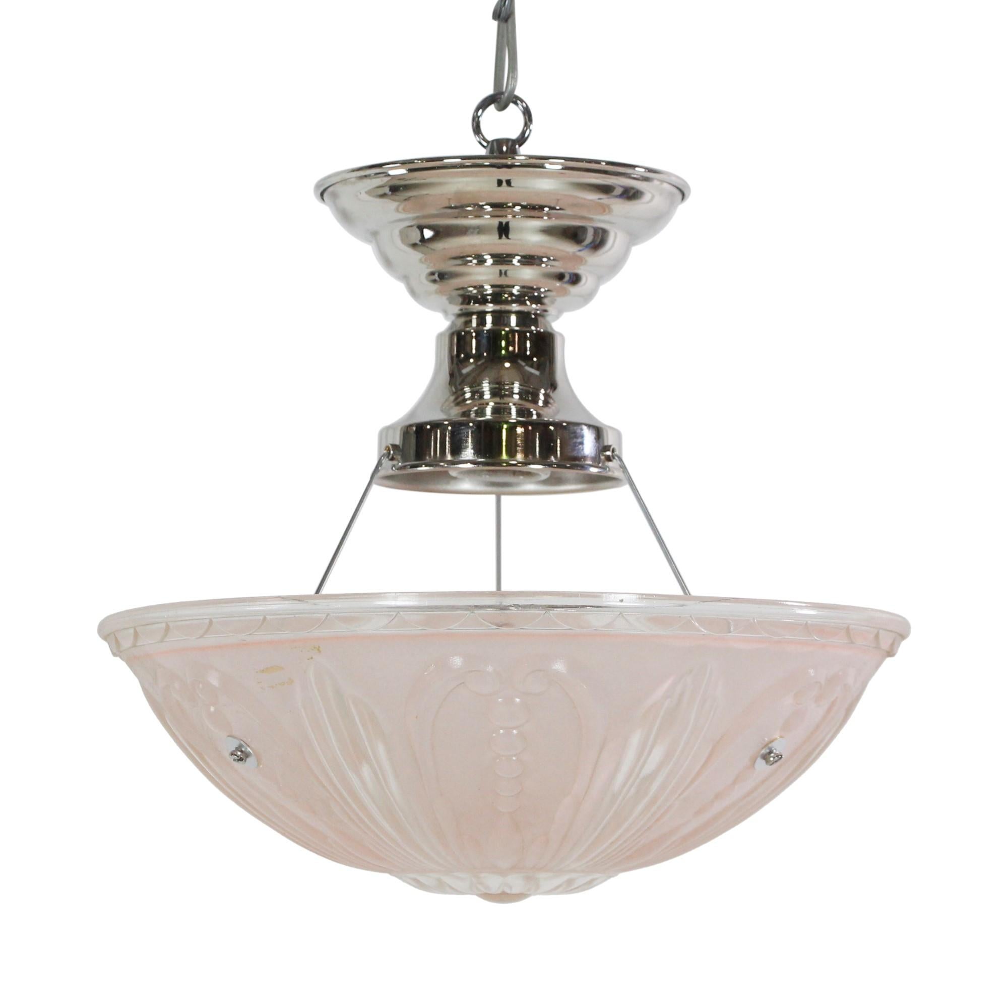 Mid 20th century pink and clear cast glass shade light mounted on a newly wired nickel finish pendant light fixture. This can be seen at our 400 Gilligan St location in Scranton, PA.