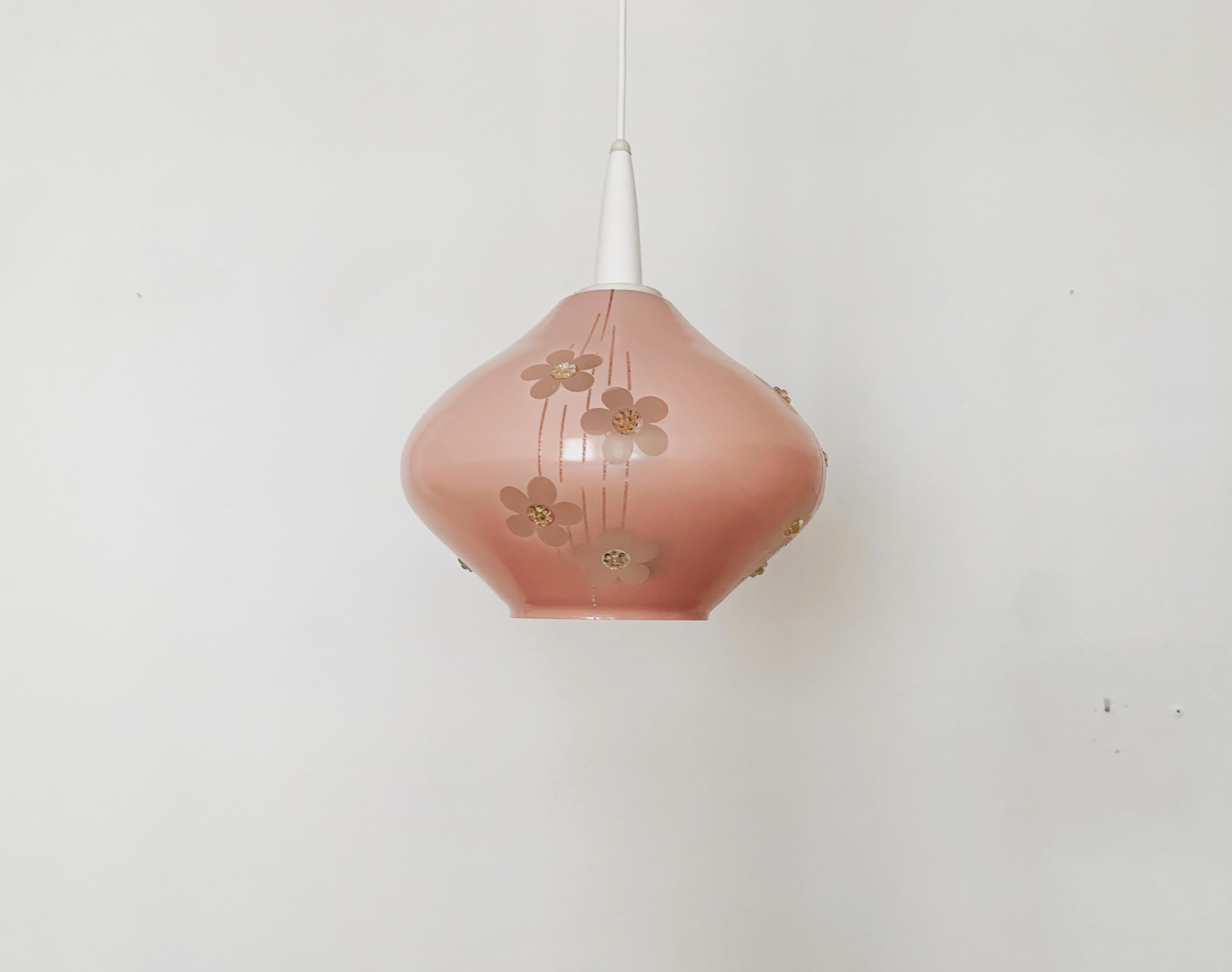 Wonderful pink glass pendant lamp from the 1950s.
The lamp is lovingly processed with special details such as the raised flowers.
A very warm light is created.

Condition:

In good vintage condition with slight signs of wear consistent with