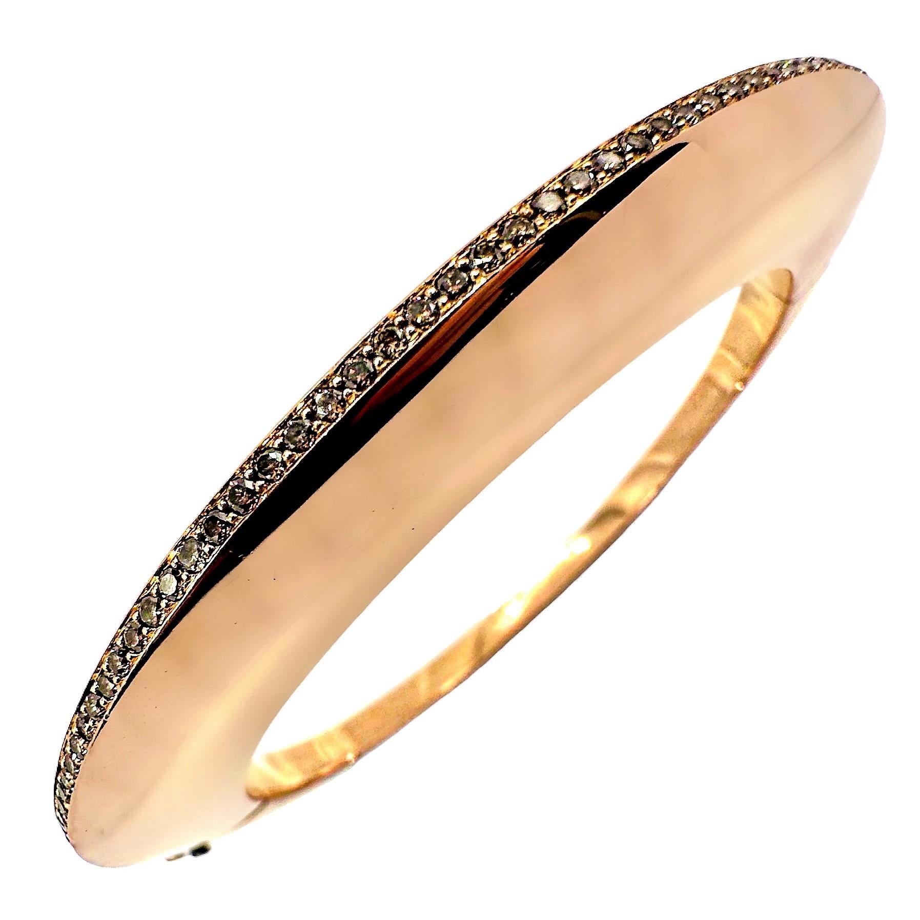 This edgy, vintage 18K pink gold and diamond hinged bangle by GEORG JENSEN is absolutely unique, with design cues that are characteristic of the maker. This dramatic and aesthetic piece is set with a line of cognac color brilliant cut diamonds that