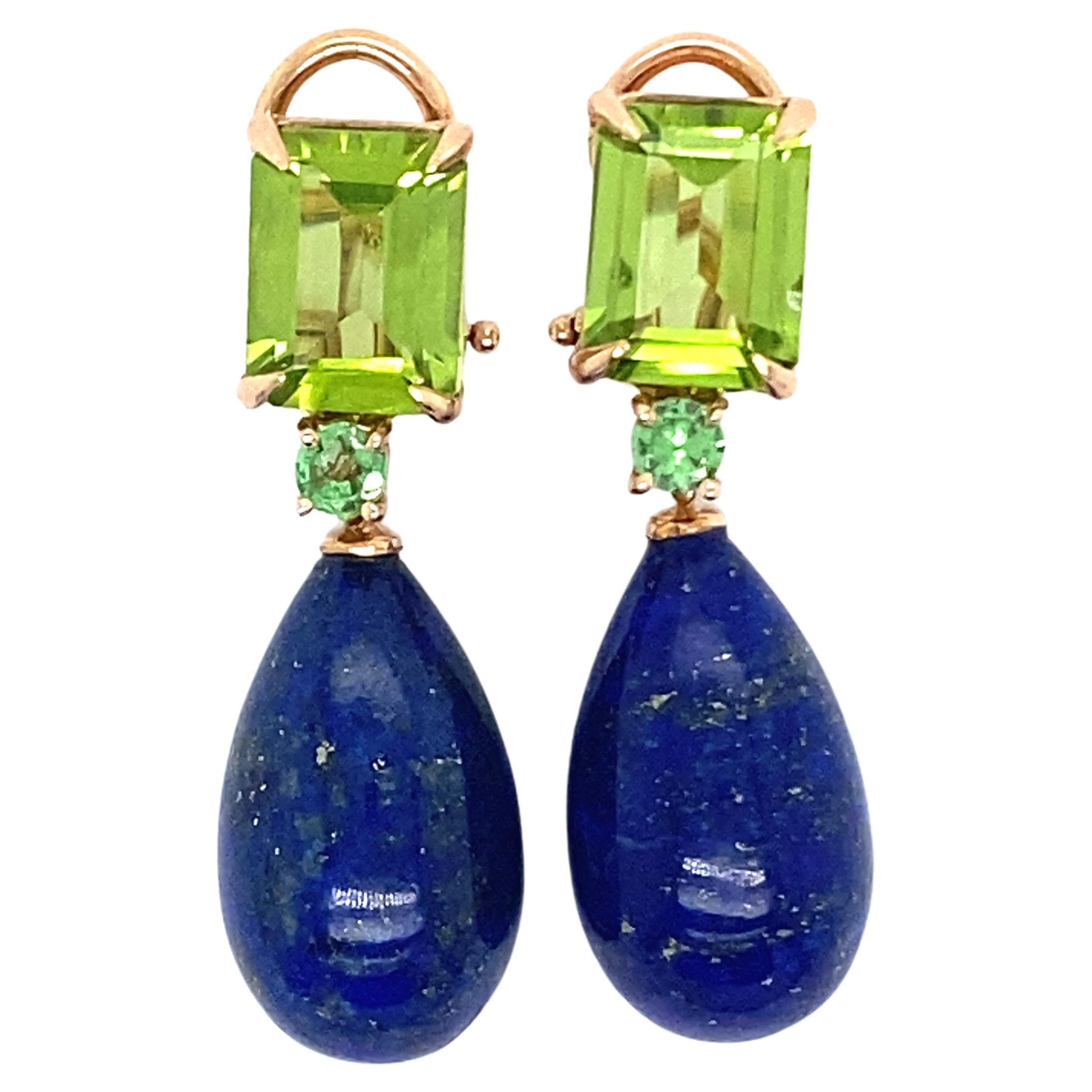 Discover these magnificent 18-carat rose gold earrings, an exceptional creation from the French collection by Mesure et Art du Temps. These earrings are truly majestic, adorned with two peridots, two tsavorites and two lapis lazuli drops, creating a