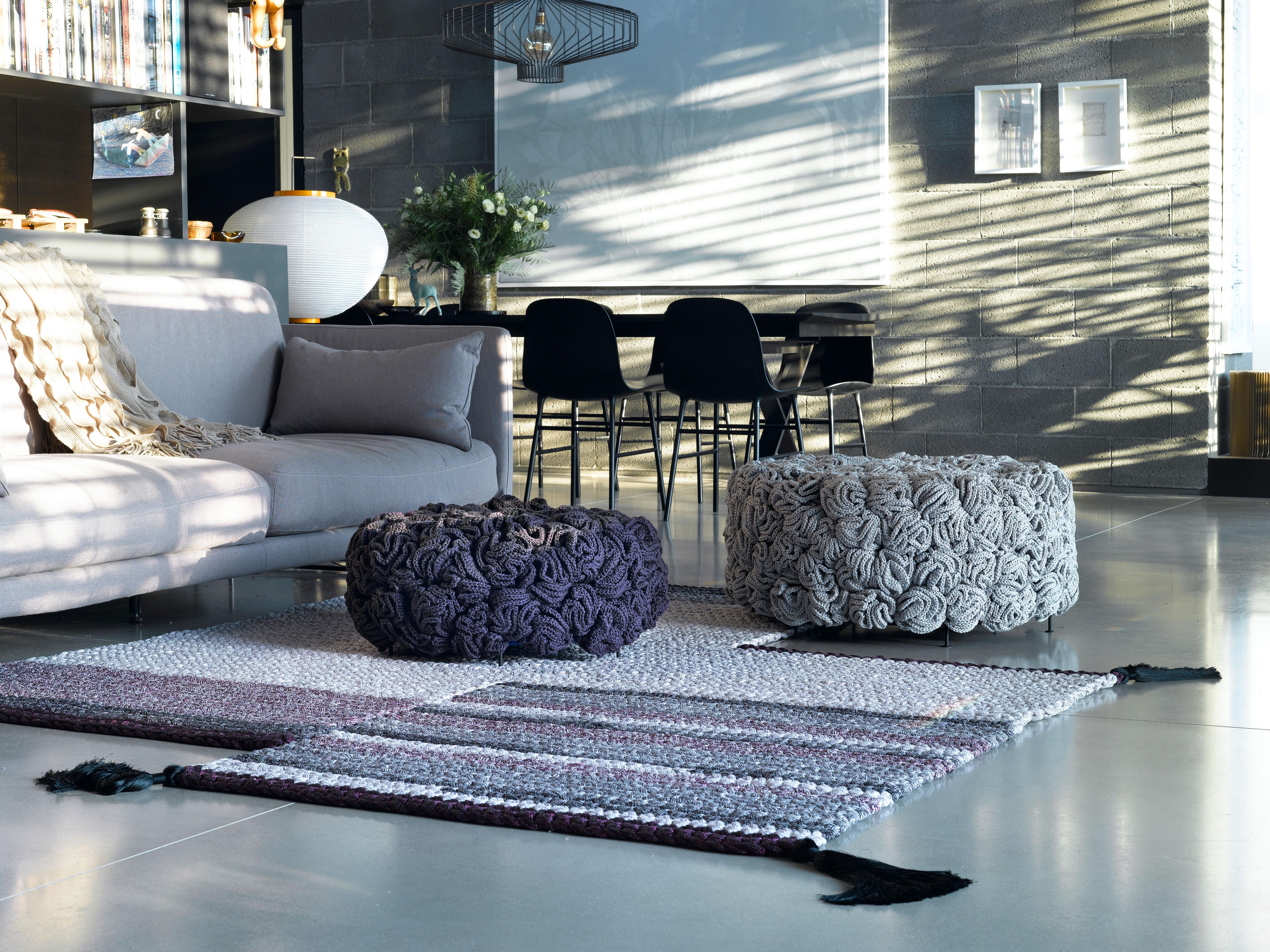 IOTA poufs challenge the classic upholstery technique and offers a new concept. The luscious, soft look and feel conceals a metal construction that gives it stiffness. The textile cover of the pouf is composed of dozens of hand knit flower-like