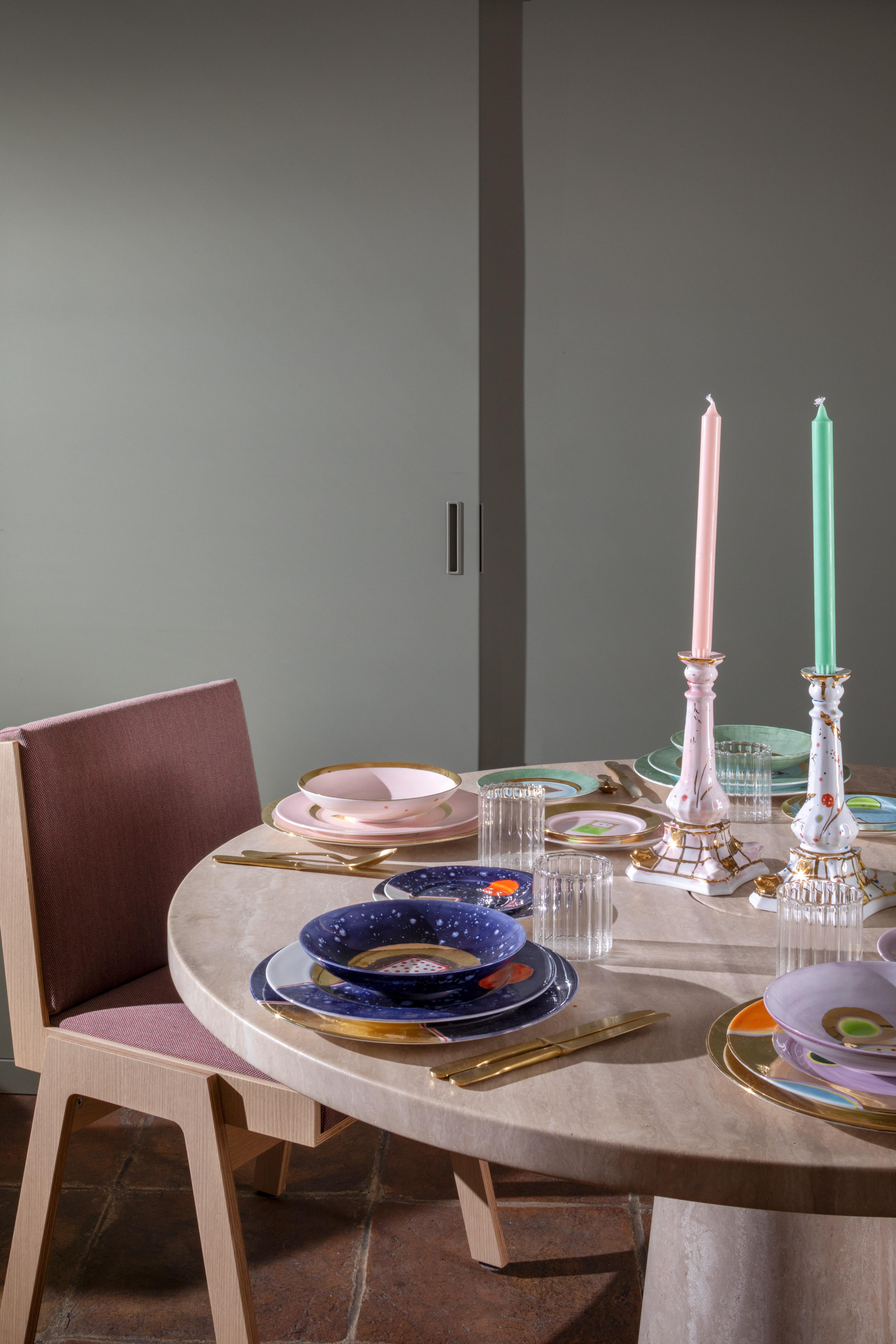 The Gold Impressions collection takes Coralla's exploration of geometry and minimalism to a new dimension, infusing her iconic designs with radiant gold accents. These golden elements transform familiar symbols, like the Mountain, into luminous