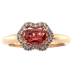 Pink Gold Ring Accompanied by Orange Sapphire Surrounded by Diamonds