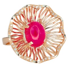 Bague en or rose avec  rubis et diamants.