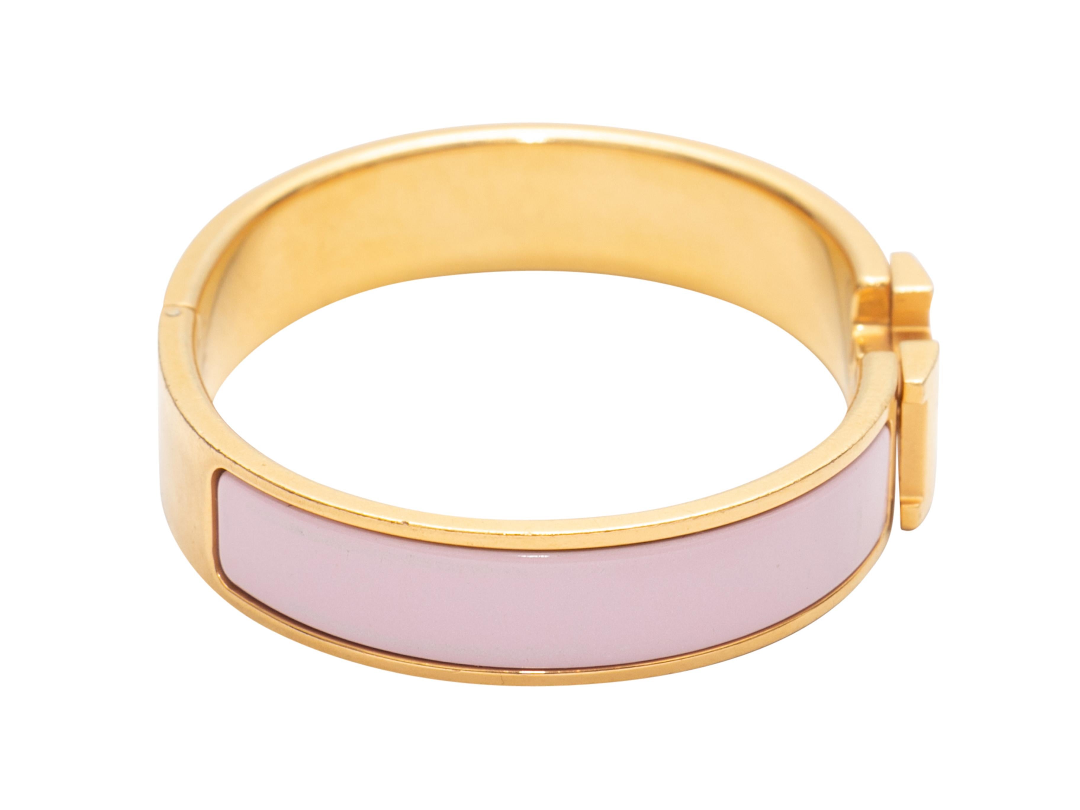 Pink and gold-tone Clic H bracelet by Hermes. 0.5
