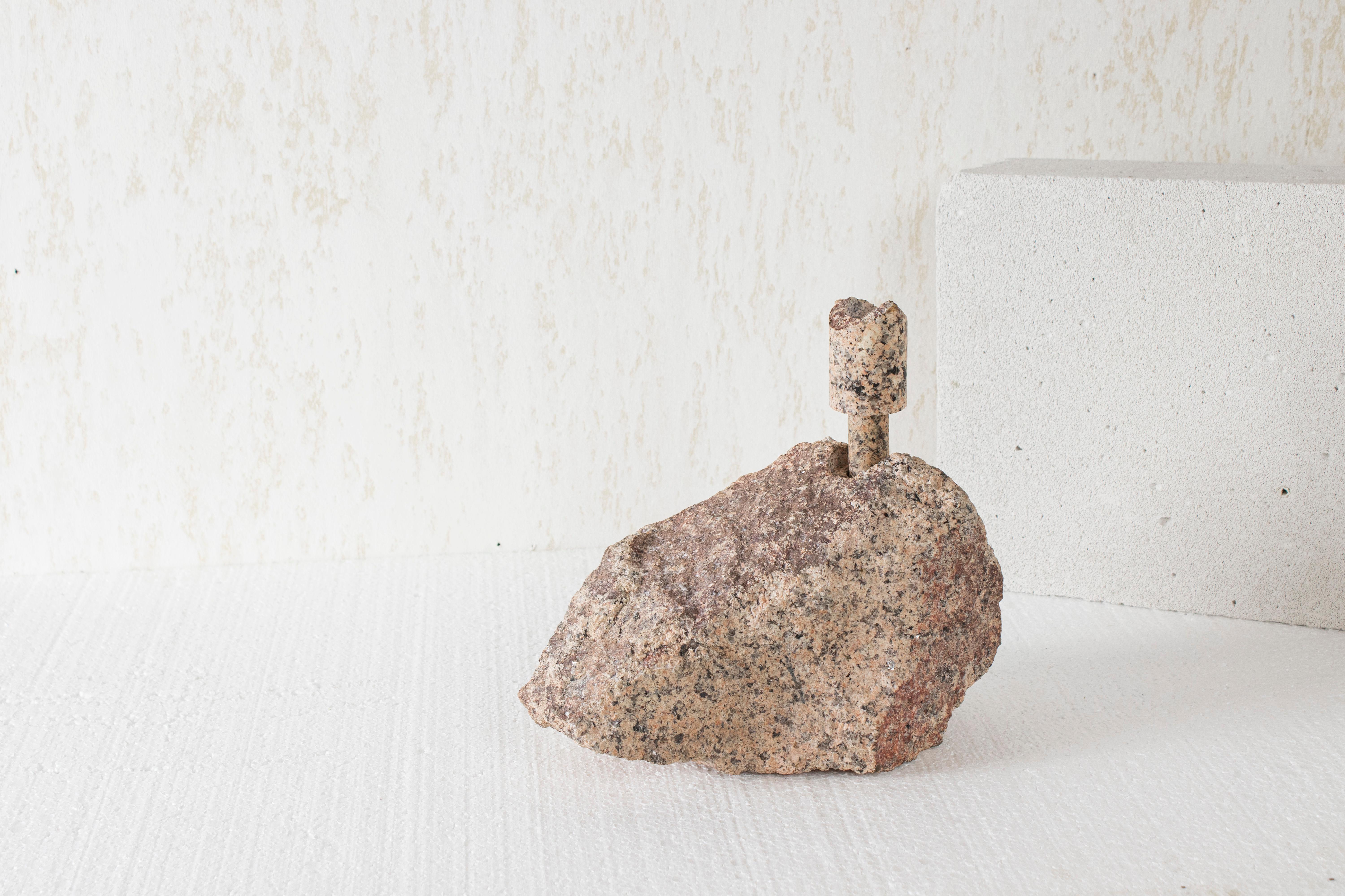 Pink Granite Abra Candelabra by Studio DO
Dimensions: D 25 x W 12 x H 23 cm
Materials: Pink granite, copper.
3 kg.

Stone and fire are connected in an ageless bond. A sparkle created by clashing two stones with each other has been igniting fire over