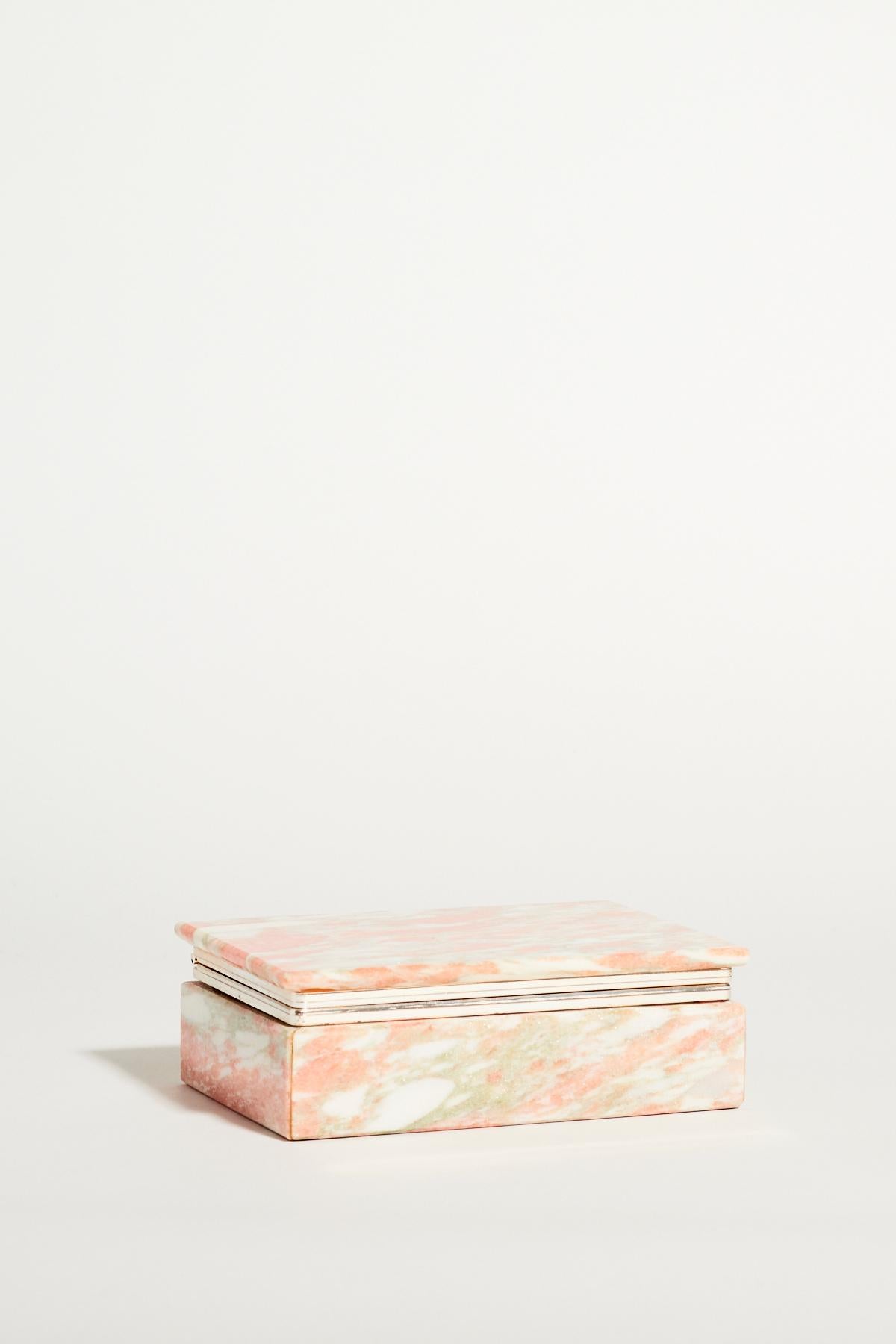 Pink, gray and white marble jewelry box with hinged lid and brass trim.