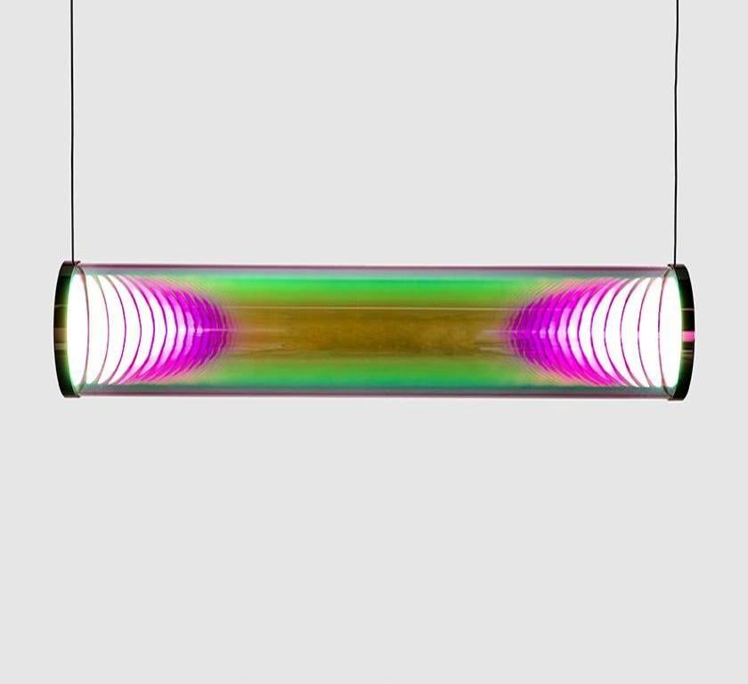 Pink-green Iris tube by Sebastian Scherer
Material: crystal glass, mirror stainless steel
Dimensions: L 70 cm x Ø 12 cm
Also available in mirror brass
Colour: Pink-green
Also available in gold-indigo, cyan-magenta, blue-orange,