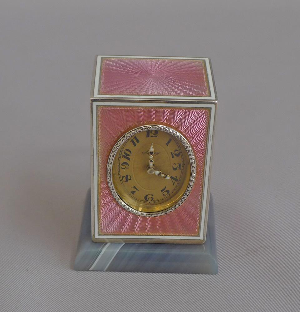 A really beautiful, high quality sub-miniature carriage or boudoir clock in the finest pink guilloche enamel over a silver gilt case with carved nephrite base. The enamel on four sides including the top, all panels in excellent condition. The pink