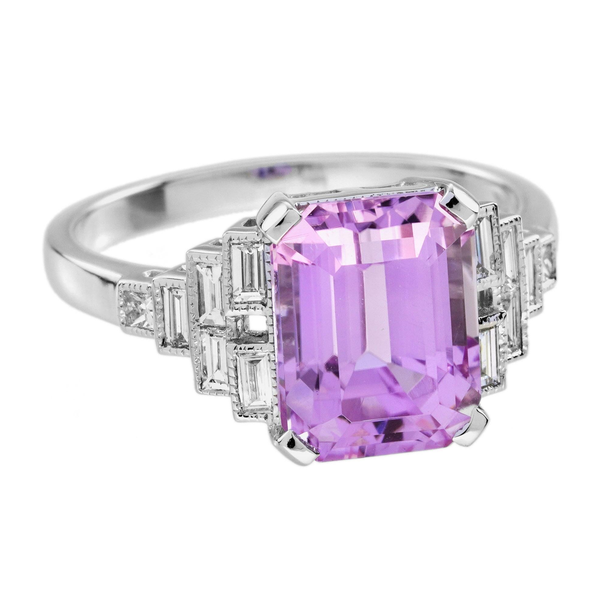 Elegant and romantic, this Art Deco style engagement ring features a stunning pink kunzite baguette at its center. Set in a sleek, geometric bezel, the centerpiece radiates soft, feminine charm. The stepped shoulders are accented with brilliant