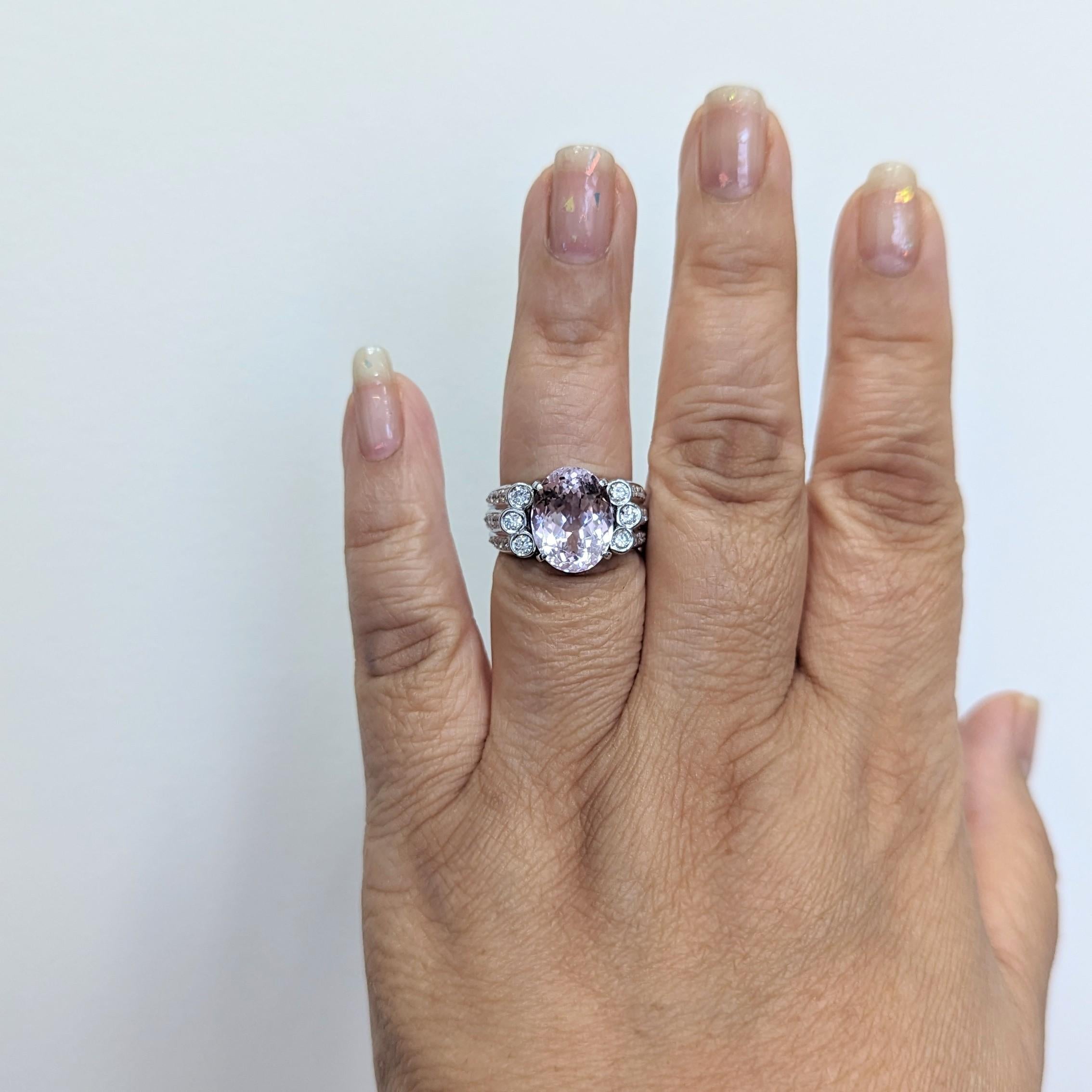 Beautiful 7.29 ct. pink kunzite oval with 0.70 ct. good quality white diamond rounds.  Handmade in platinum.  Ring size 7.