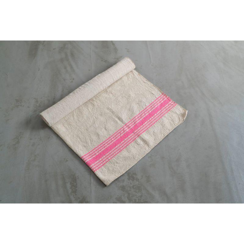 The wide pink stripes of this linen rug add a fun touch to this gentle work of fabric, a timeless example of the simple appeal of woven linen, perfect for a living room, bedroom, office, or entry.

Weaving is much older than recorded history. No