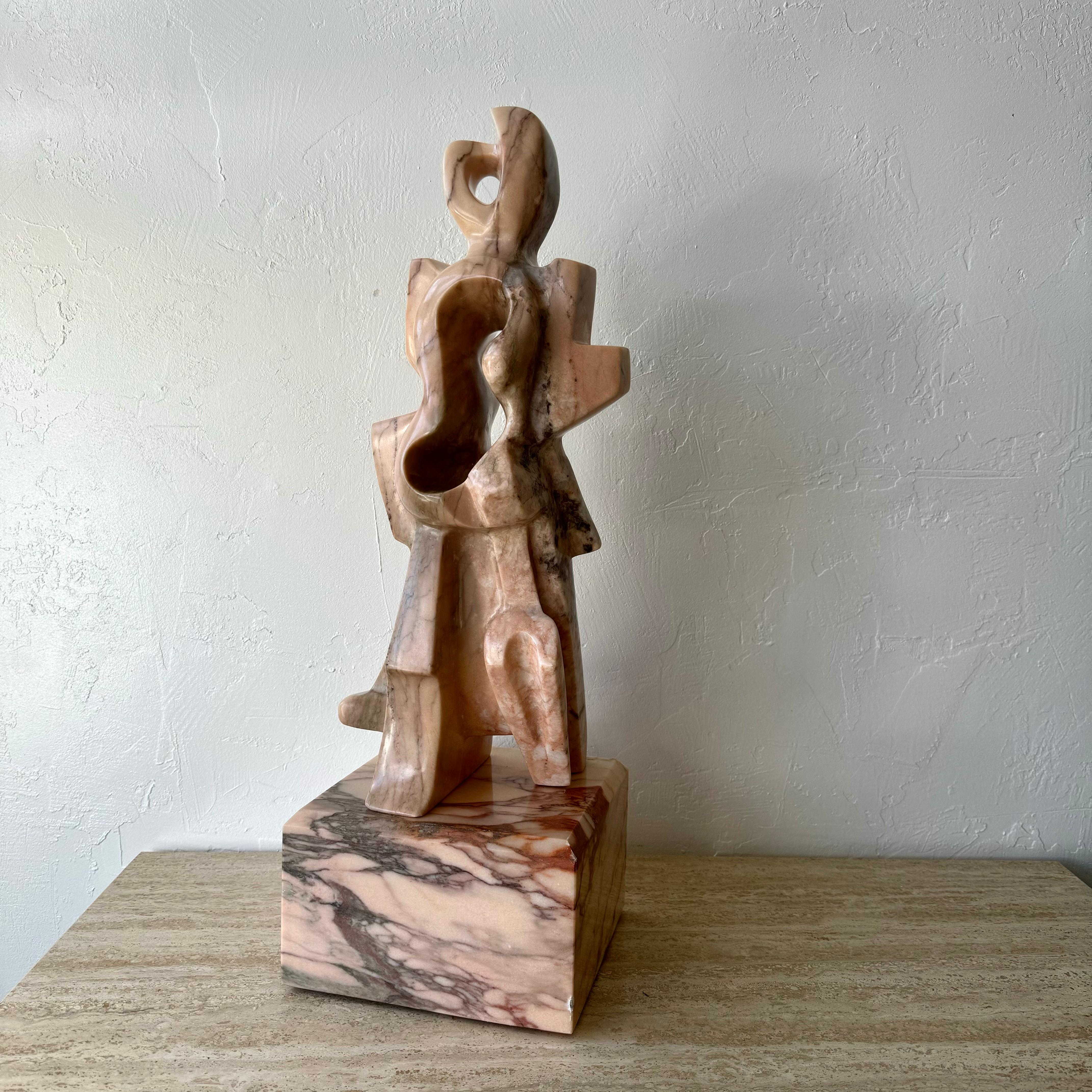 An exceptional and commanding abstract sculpture with heavy influences of Jacques Lipchitz. Sculpted out of a beautiful pink marble with subtle hints of green streaks throughout the stone. Signed Bernie on the base. 