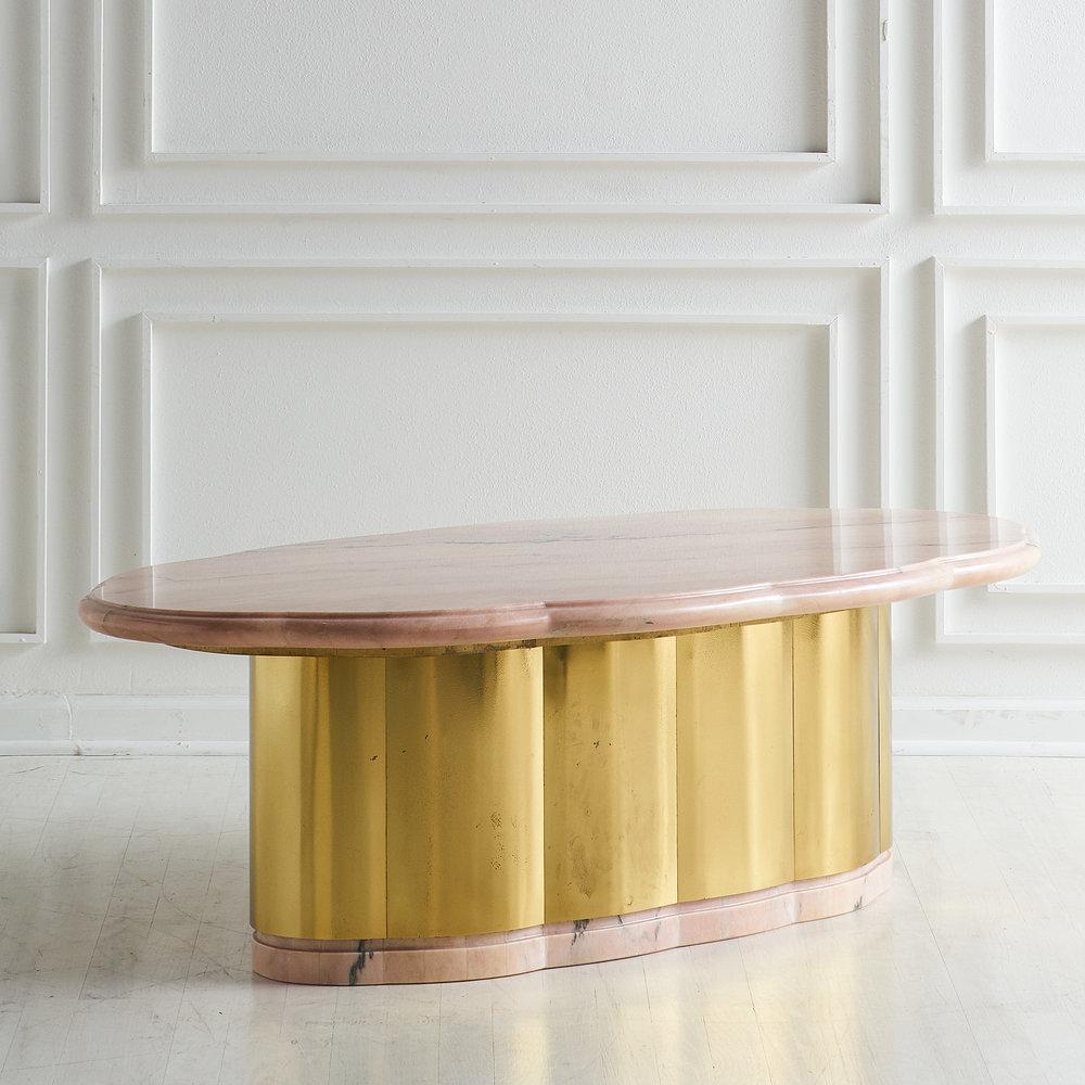 A unique pink marble top coffee table with a beautiful scalloped, beveled and polished marble top with a scalloped warm brass base. Finished with a pink marble trim at the base. This table is substantial and we believe is a custom designed piece