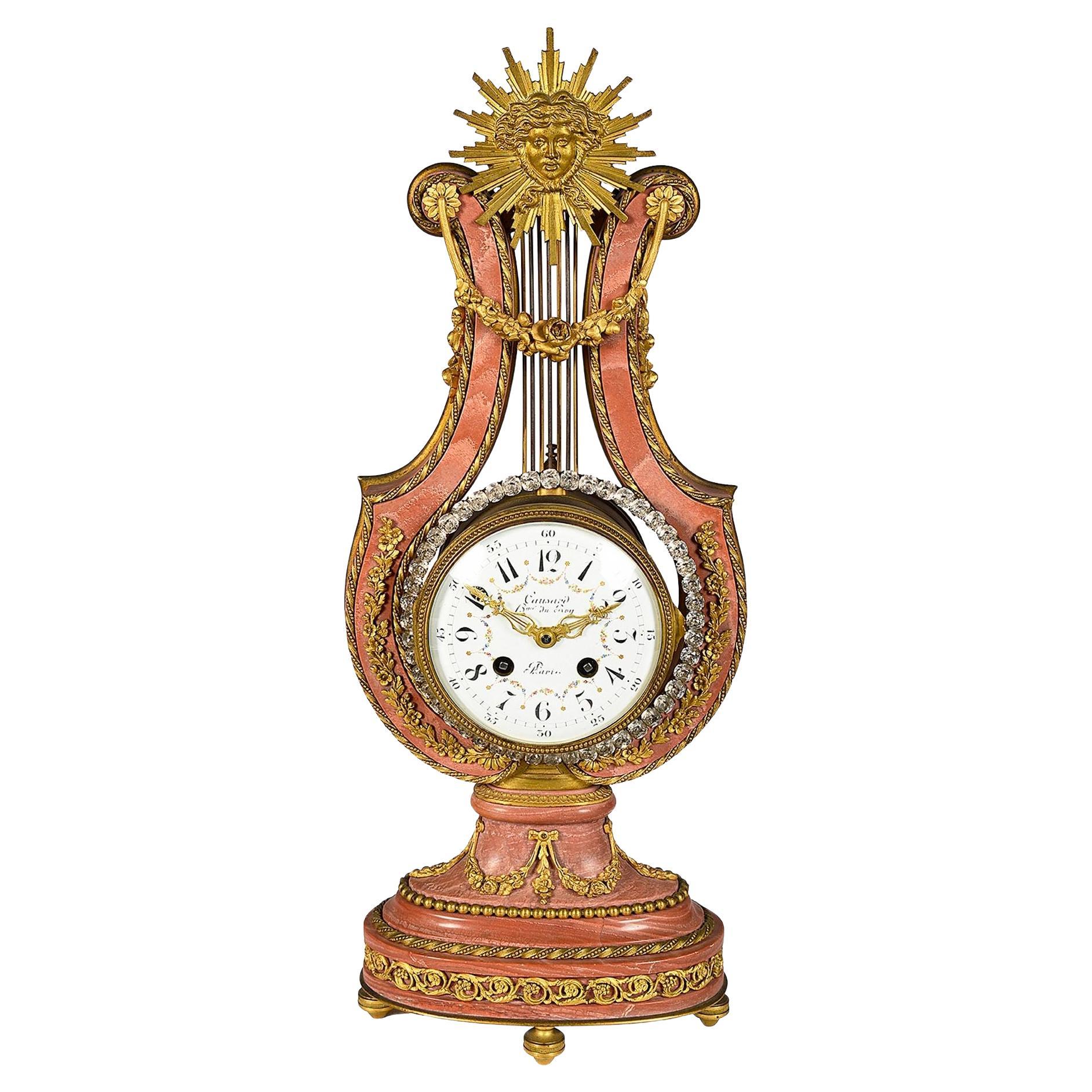 Pendule de cheminée en marbre rose de forme lyre, 19e siècle.