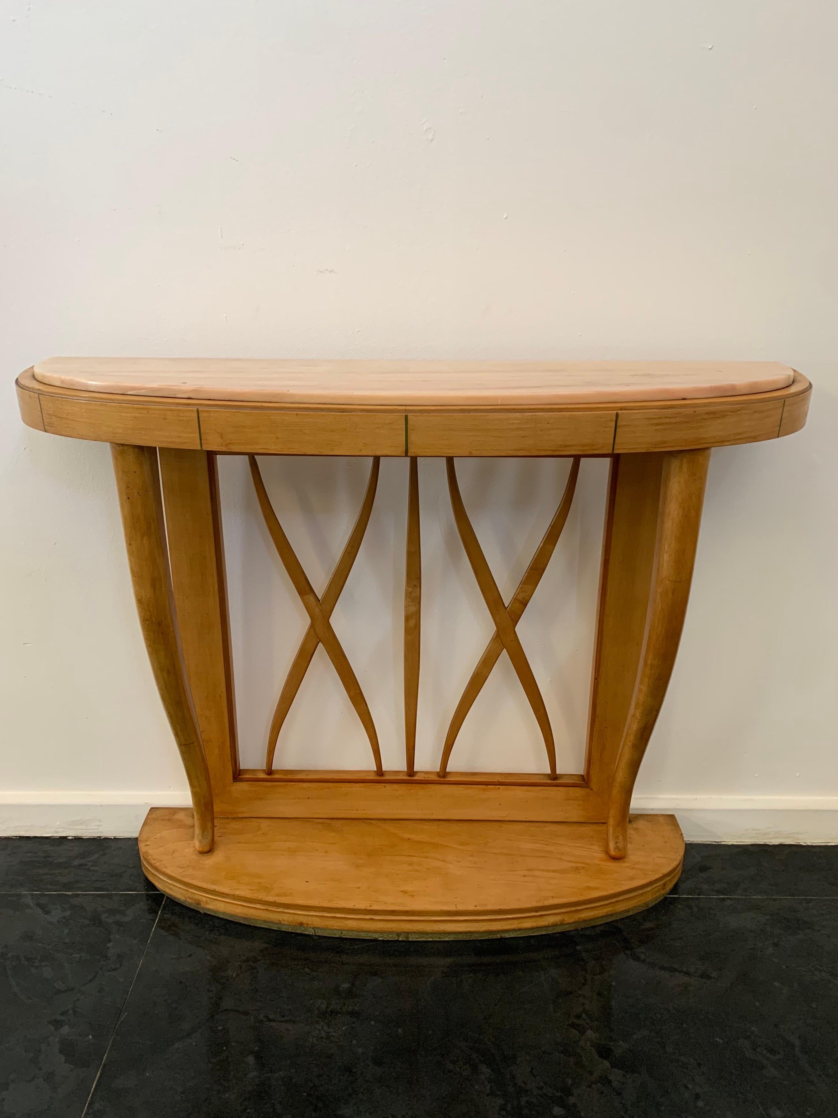 Maple console table with pink marble top, 1940s. Base profiled at the bottom by a green lacquered line from which depart two rounded pilasters that widen upward to accommodate the generously thick half-moon top; on the front small vertical green