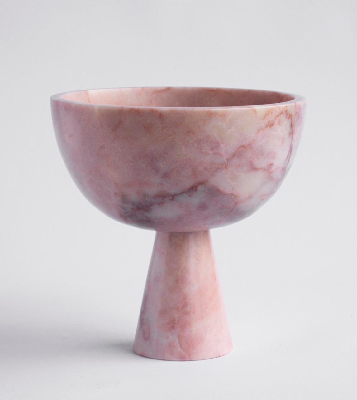A substantial pink marble bowl with unique white veining rests atop a pedestal for a grand presentation of fruits and vegetables. 

Exposure to the acid of citrus fruits can stain marble. Due to the natural properties of marble the colour and
