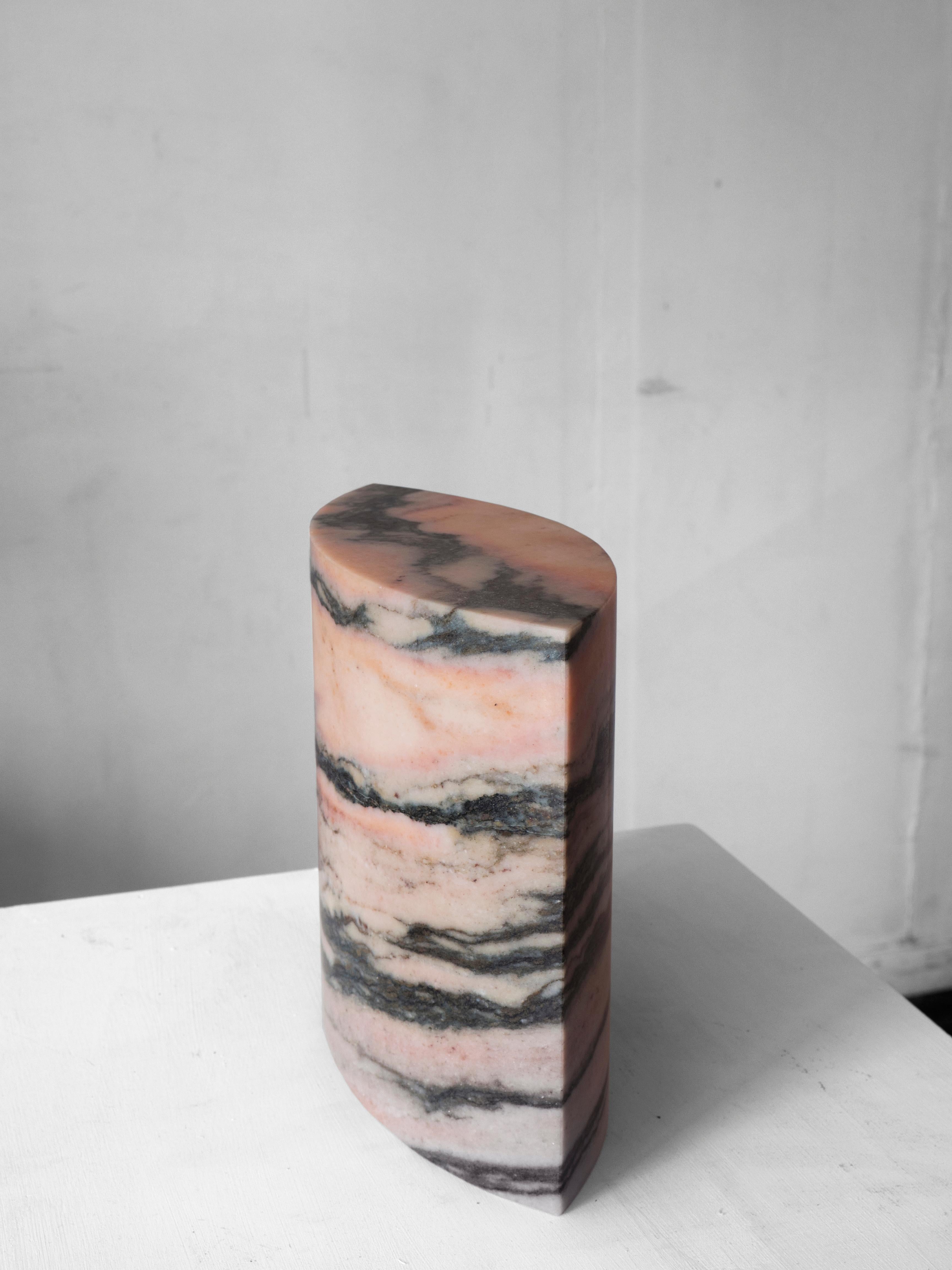 Information:
The sculpture is hand carved out of pink marble with black and gray shades. The stone’s natural character emerges through the contrasting softness and sharp lines. The surface is sanded and finished with a clear silky wax.

Material: