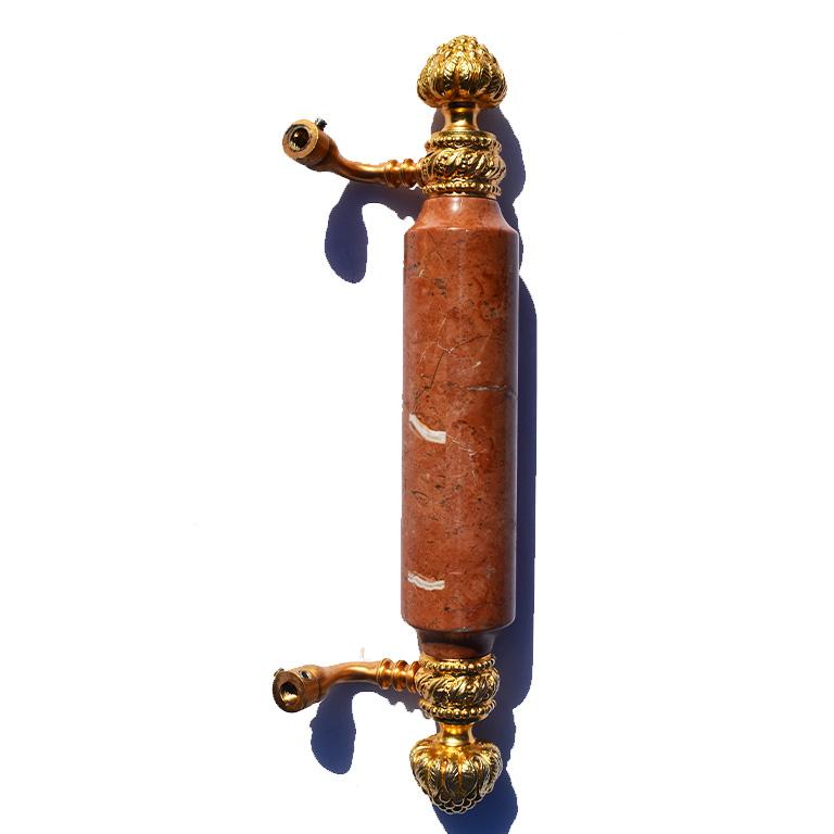 Oversize shower or door bar pull, by Sherle Wagner. This beautiful handle features a large heavy pink marble stone center bar, connected by gold-plated hardware. At both the top and bottom each pull shows a grouping of grapes as well as other
