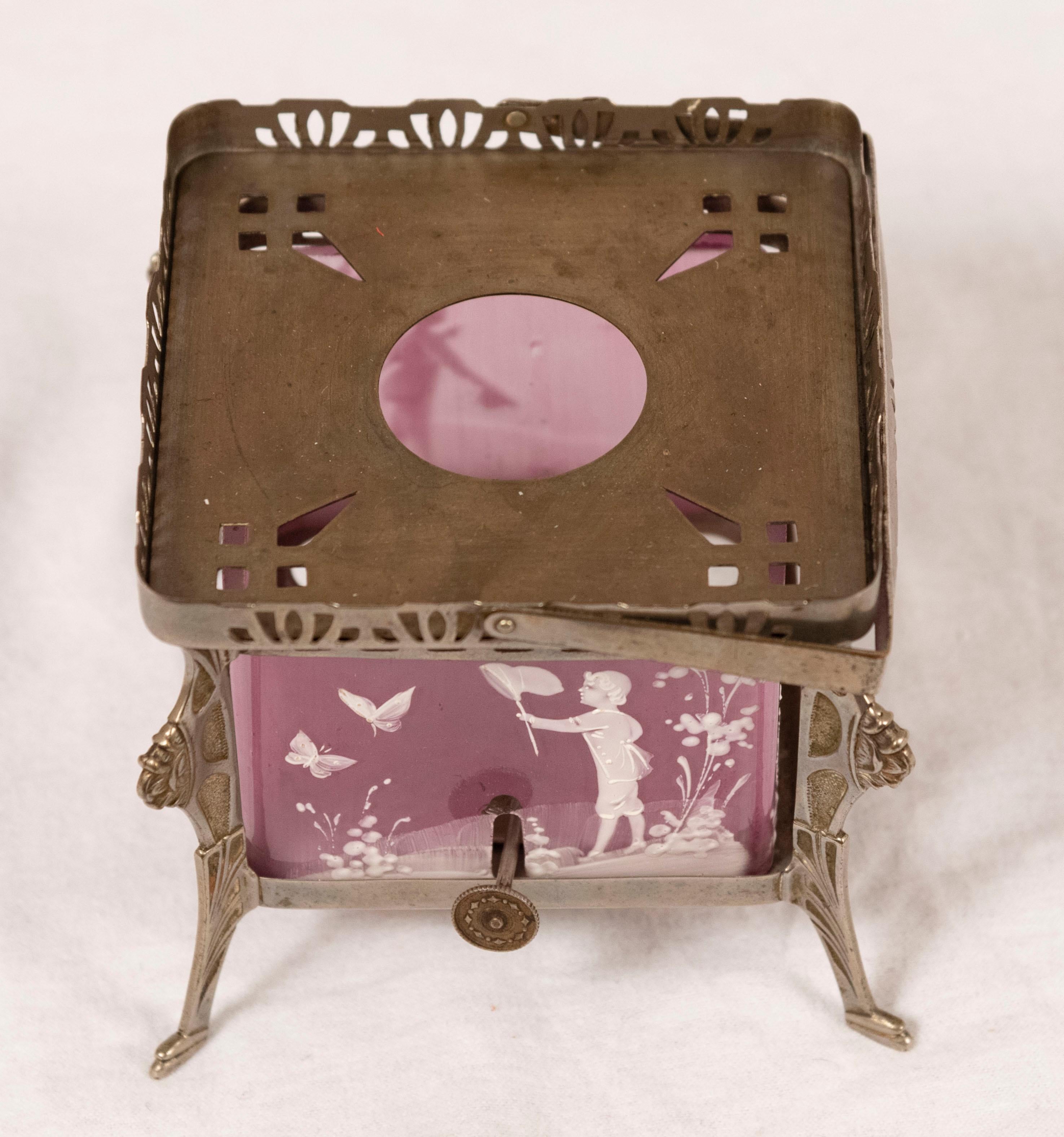 Mary Gregory (American, 1856-1908) pink tea warmer with painted art glass and silver plate

Measures: 4.5 x 5 x 5 inches.
