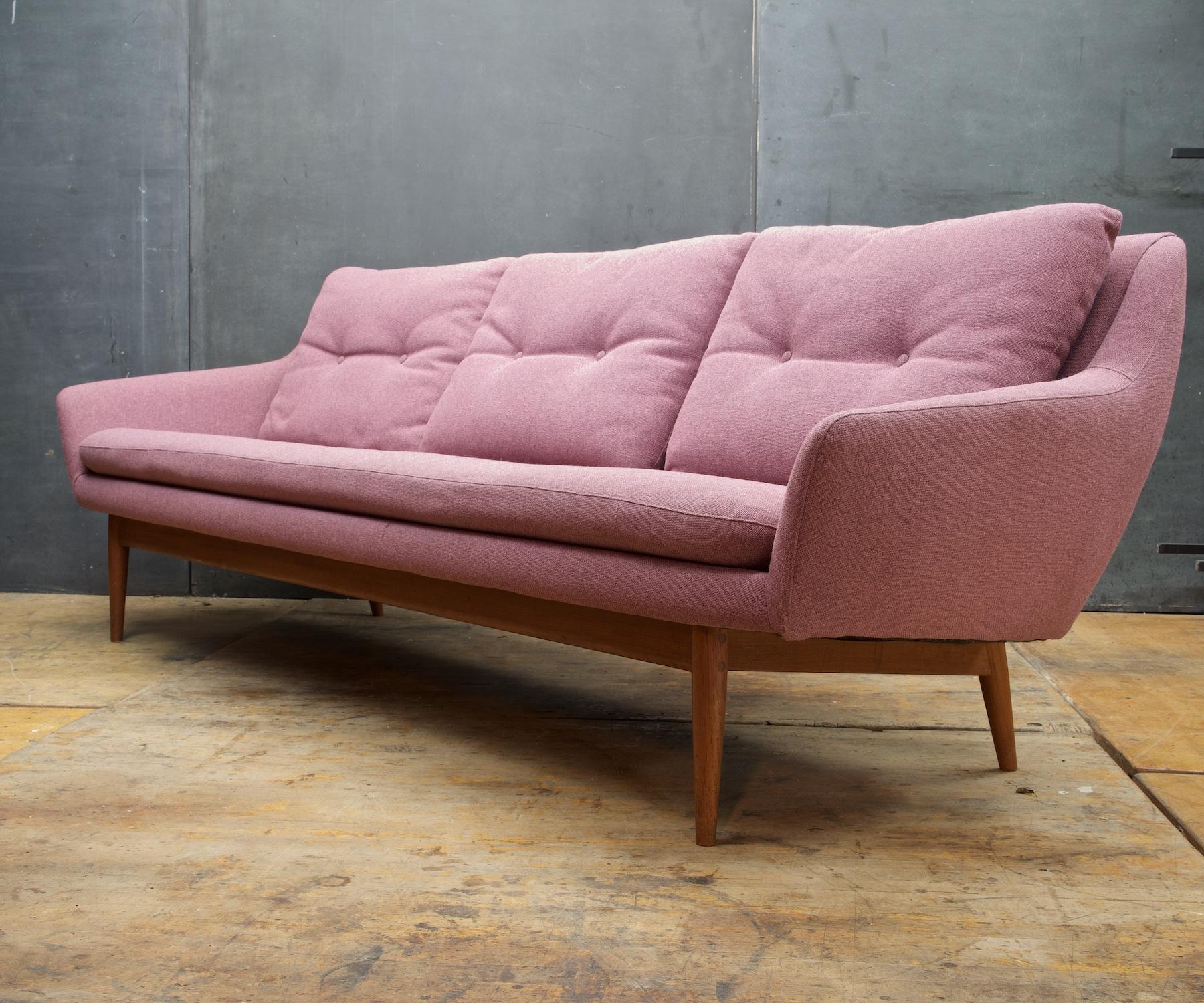 Wonderful architectural designed sofa by L.K. Hjelle of Norway. Solid teak legs and base. Showing some wear, reupholstery is 3 years old. Seat Height is about 16.5-17.5 and the arms are 22 high.

Last image shows the pink-mauve fabric color in