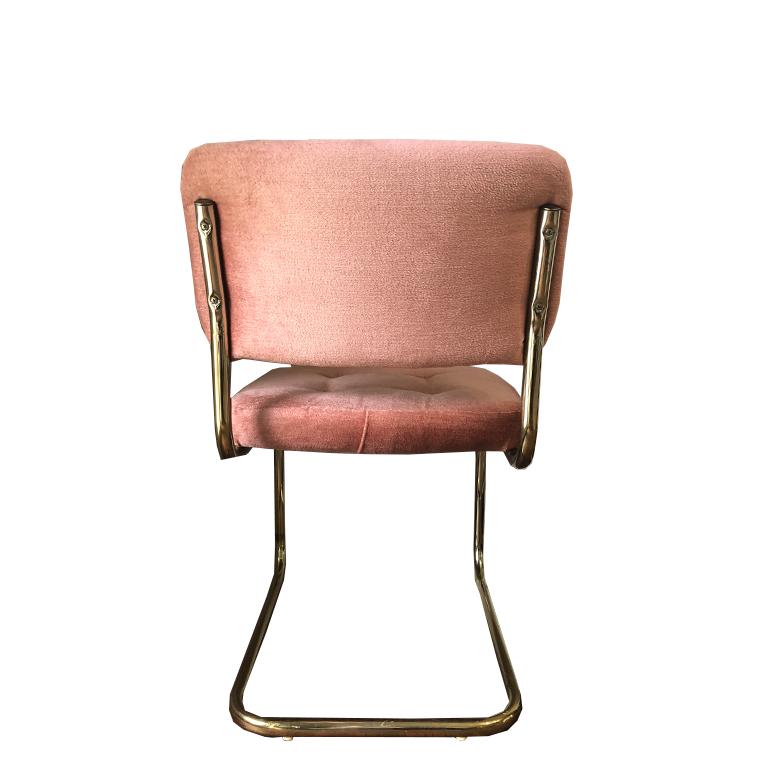 Four pink cantilever chairs with gold bases. Set includes a matching dining table and glass top. The table is round, and made of wood, brass and glass. Excellent condition. 

Measures: Chairs:
Seat height 19