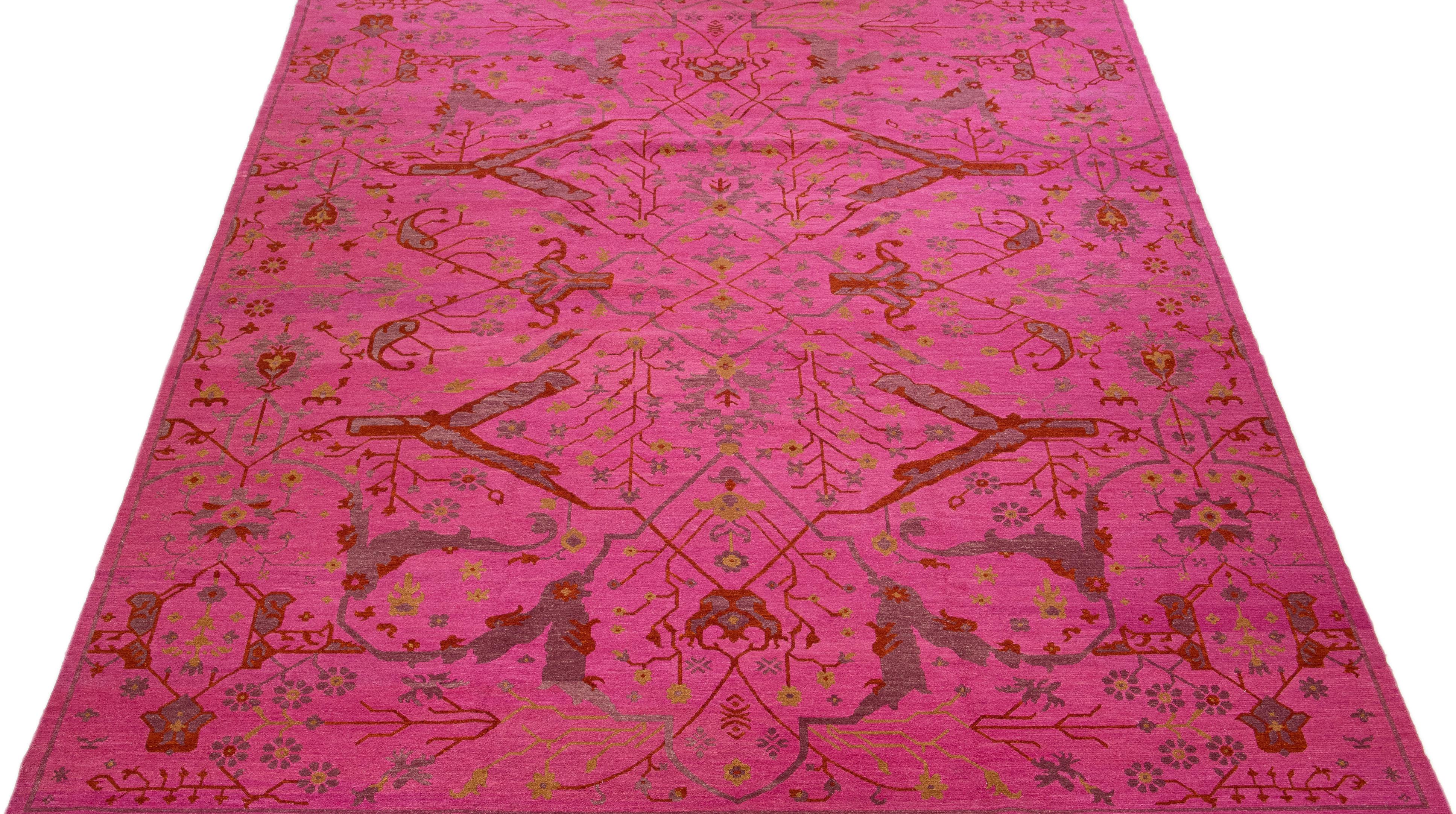 Beautiful antique Indian hand-knotted wool rug with a pink color field. This piece has a gorgeous allover floral design in rust, gray, and goldenrod colors.

This rug measures 12' x 15'.

Our rugs are professional cleaning before shipping.