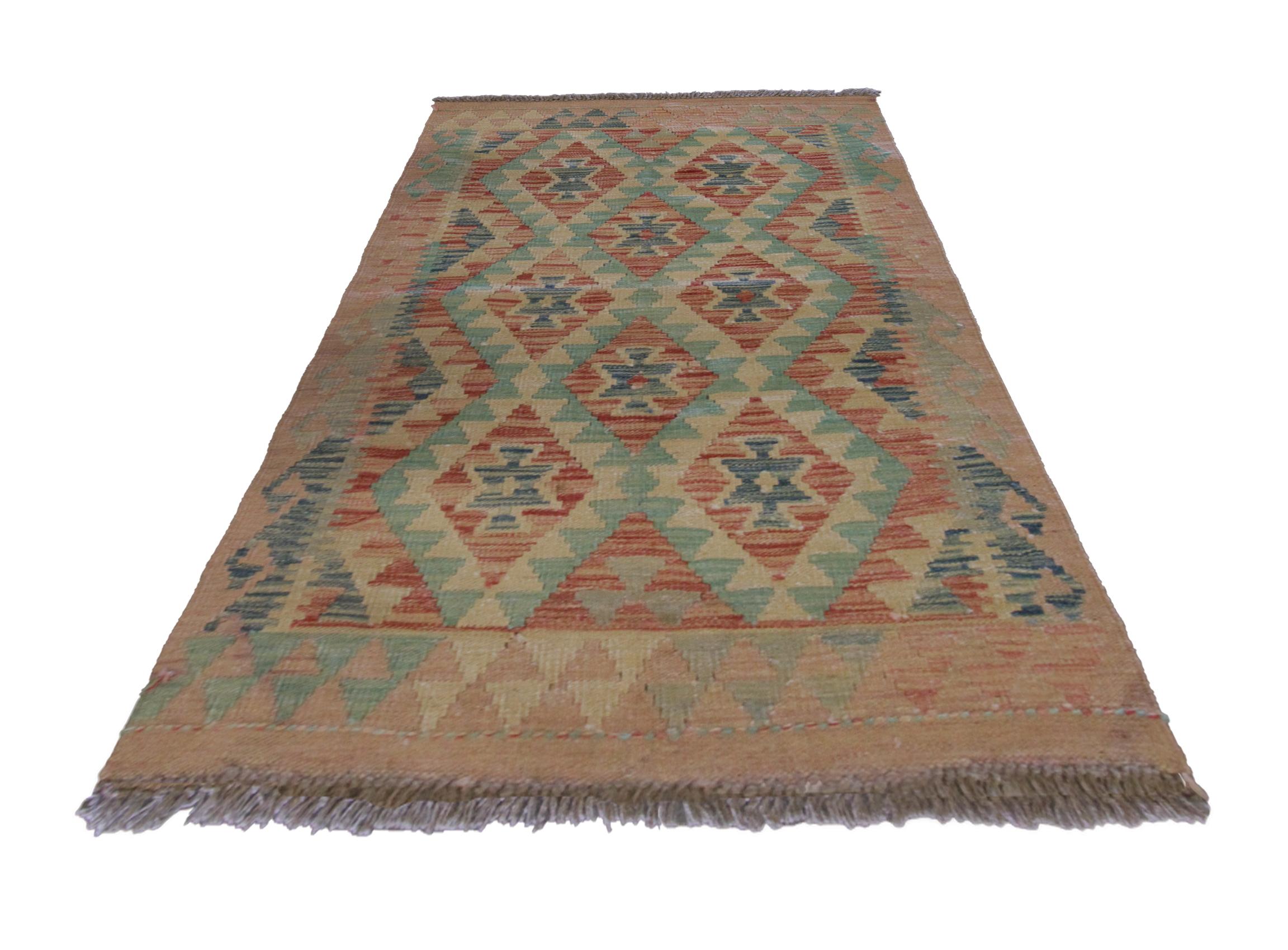 This bold wool area rug has been woven with a symmetrical geometric diamond design with geometric motifs woven in the centre of each diamond. Woven with a beautiful colour palette including pink, blue, beige, rust and red. A geometric hook border