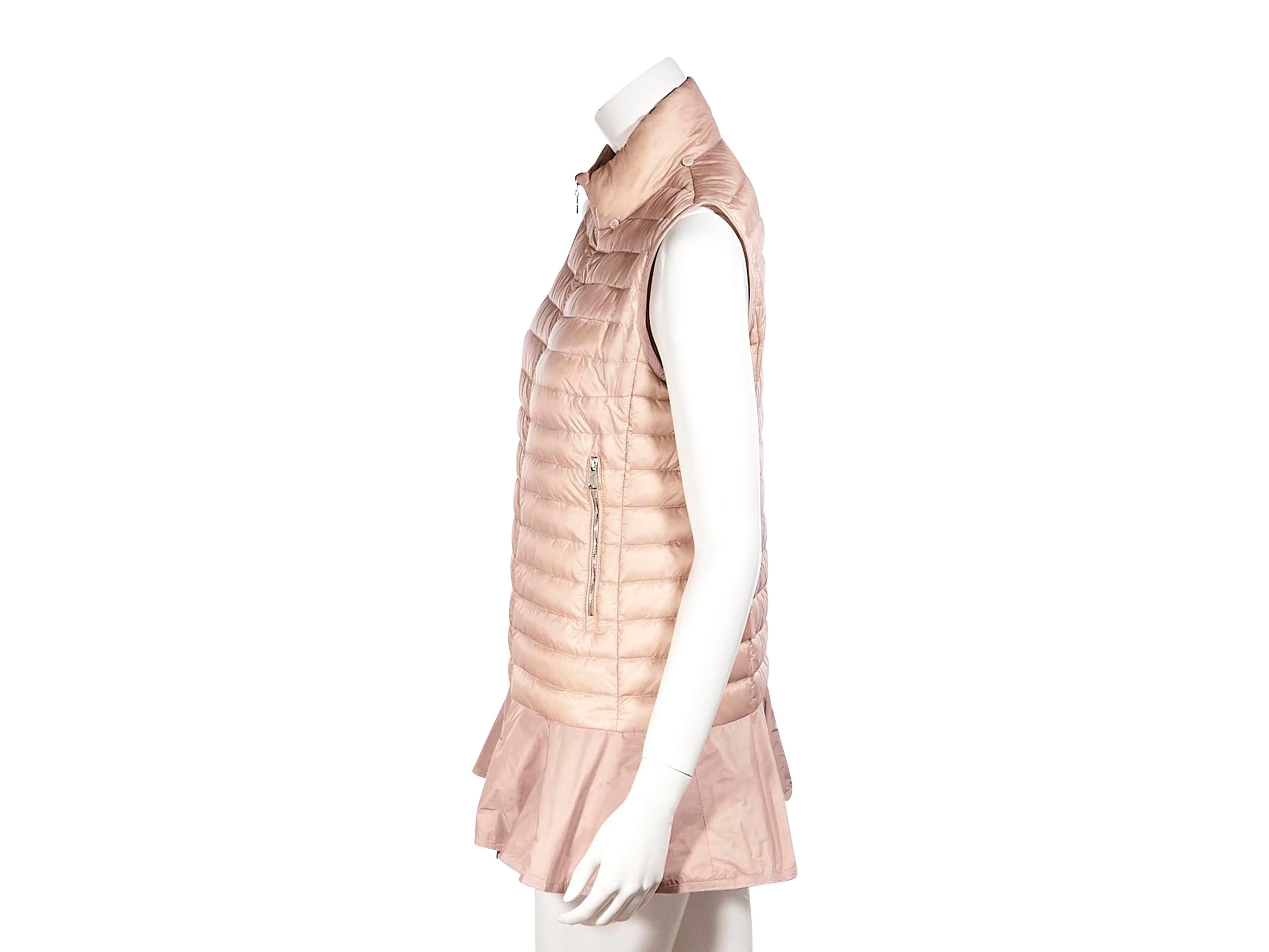 Product details:  Pink puffer down vest by Moncler. High collar. Goose down filled. Zip side pockets. Ruffled hem. Zip front closure. Gold-tone hardware. Pair yours with a cashmere long sleeve sweater. 36