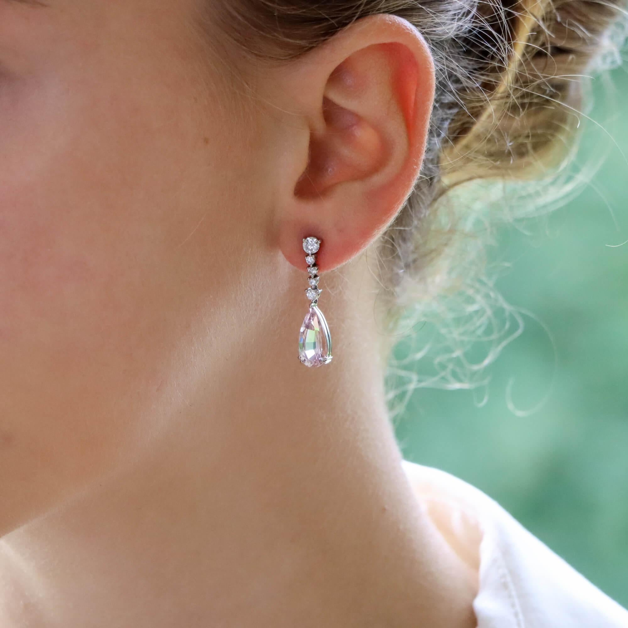 A beautiful pair of pink morganite and diamond drop earrings set in 18k white gold.

Each earring is predominantly set with a lovely pear cut baby pink coloured morganite stone. This morganite is claw set in an open back setting and is suspended