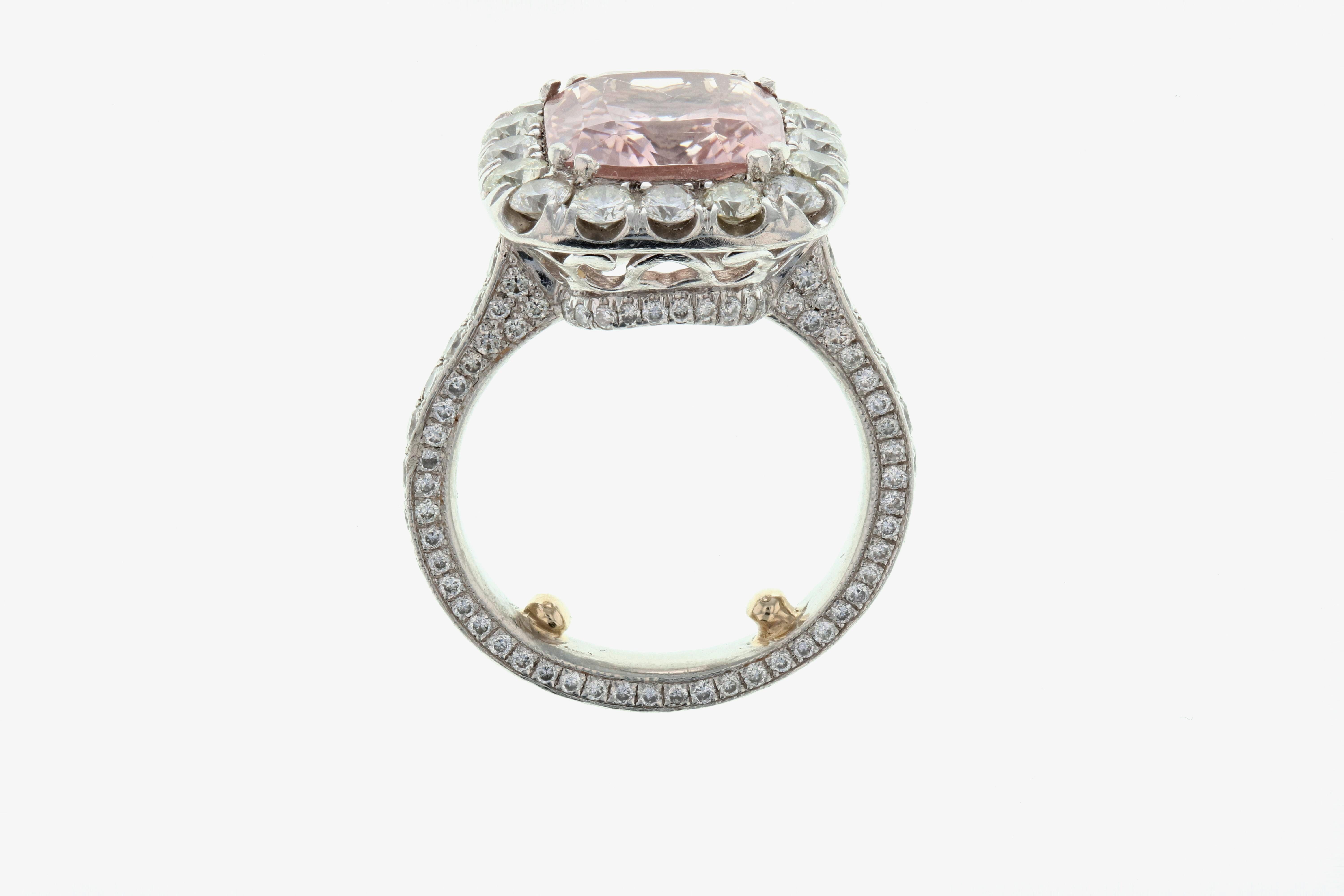 This beautiful pink morganite ring has a 4.10 center cushion cut pink morganite and 2.06 carats of round white diamonds.  Set in platinum, the ring has sizing beads which can be removed. 

Please note that each piece we make is customized to our