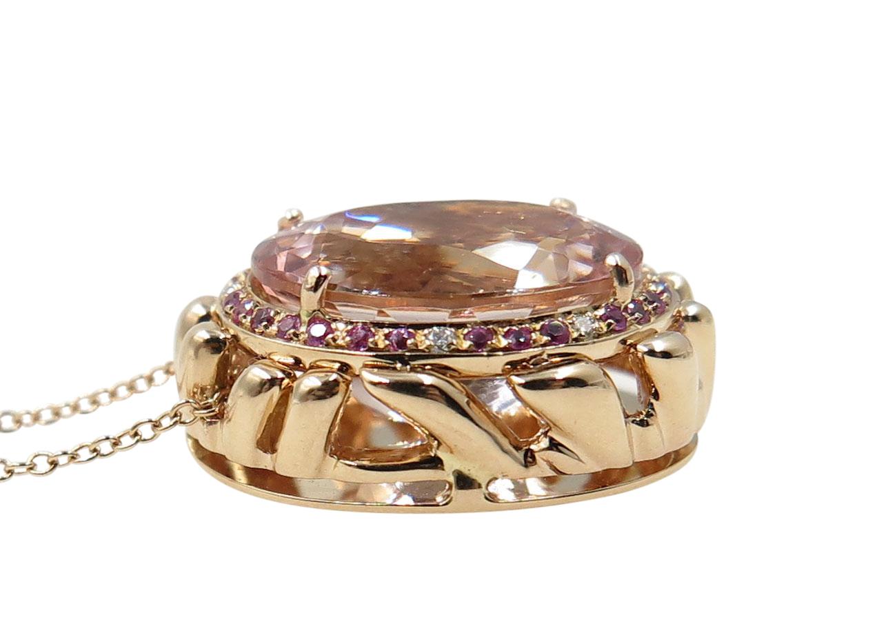 13,21 Carat of pink Morganite set with pink sapphires and diamonds in 18 karat rose gold.