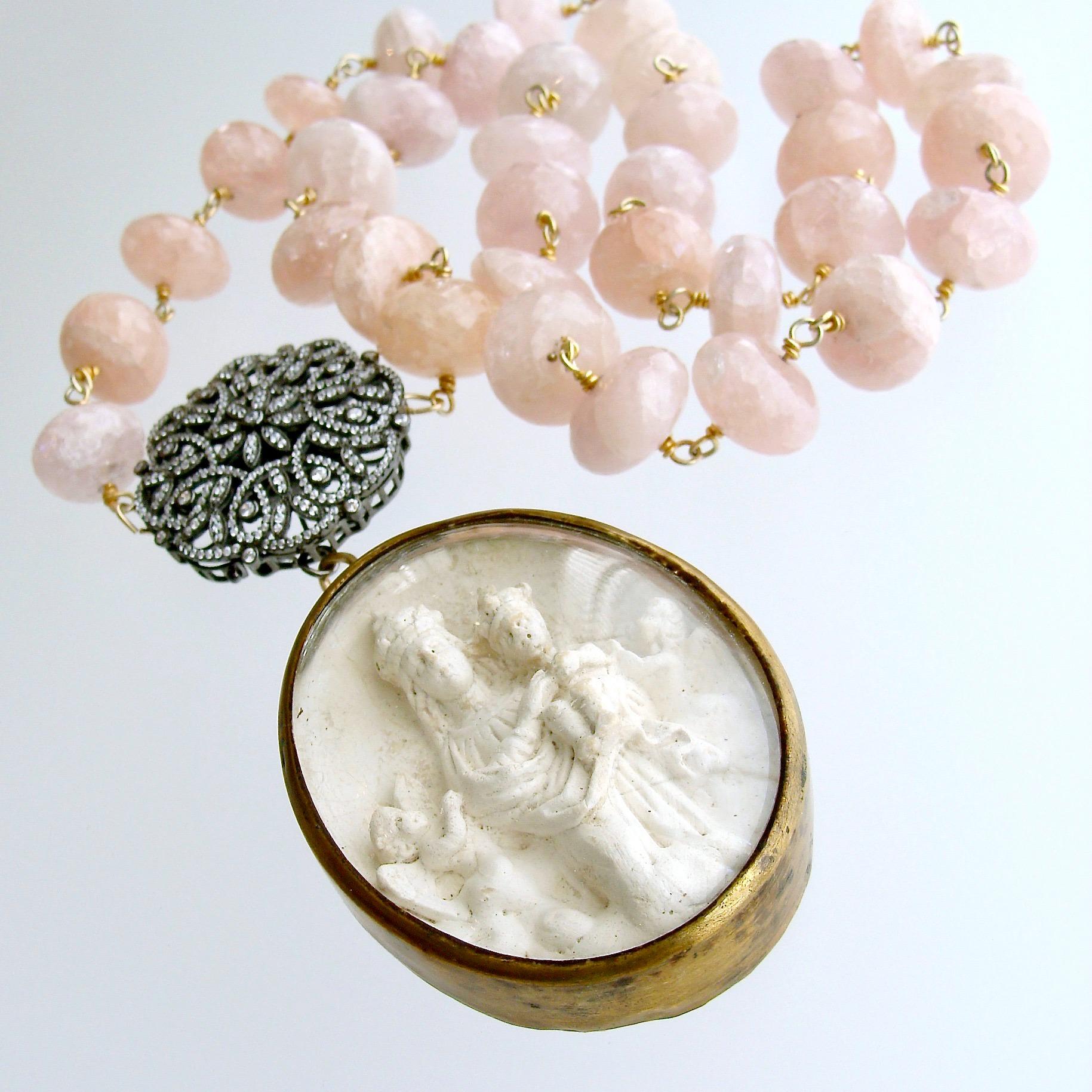 Madonna Necklace.

A luxurious strand of hand-linked pink morganite leads the eye to a gorgeous rhodium silver filigree clasp, then drops to feature a  remarkable antique French Meerschaum reliquary Ex Voto of Mary and Baby Jesus with sweet little