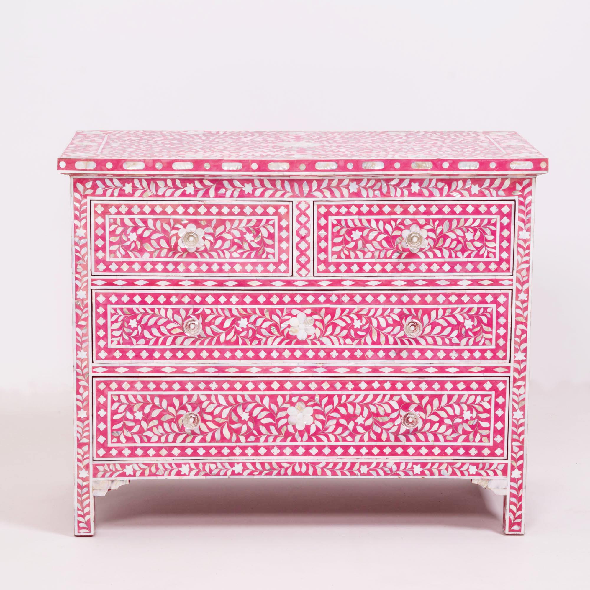 Handcrafted in Jaipur, India by skilled artisans, this classic mother of pearl inlay chest of drawers and matching scalloped mirror is crafted from sustainable mango wood, fixed into strawberry resin resulting in an eye catching floral design. With